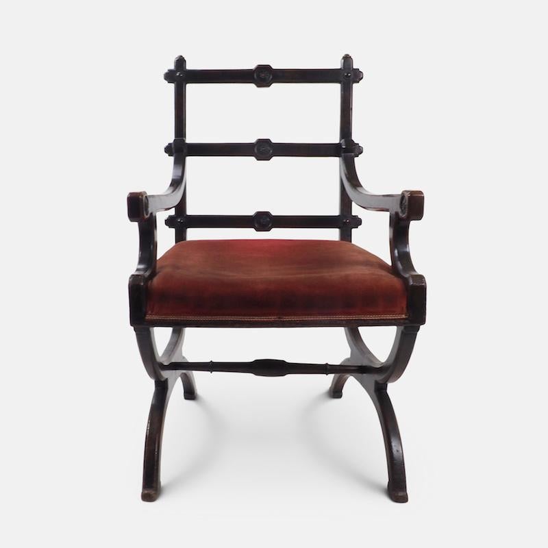 Aesthetic movement chair in the style of A.W.N Pugin

An imposing Neo Gothic form dating from the last quarter of the 19th century. Chair has chamfered top rails, arms and legs; tusk and pegged tenon joint back rails carved with central rosettes.