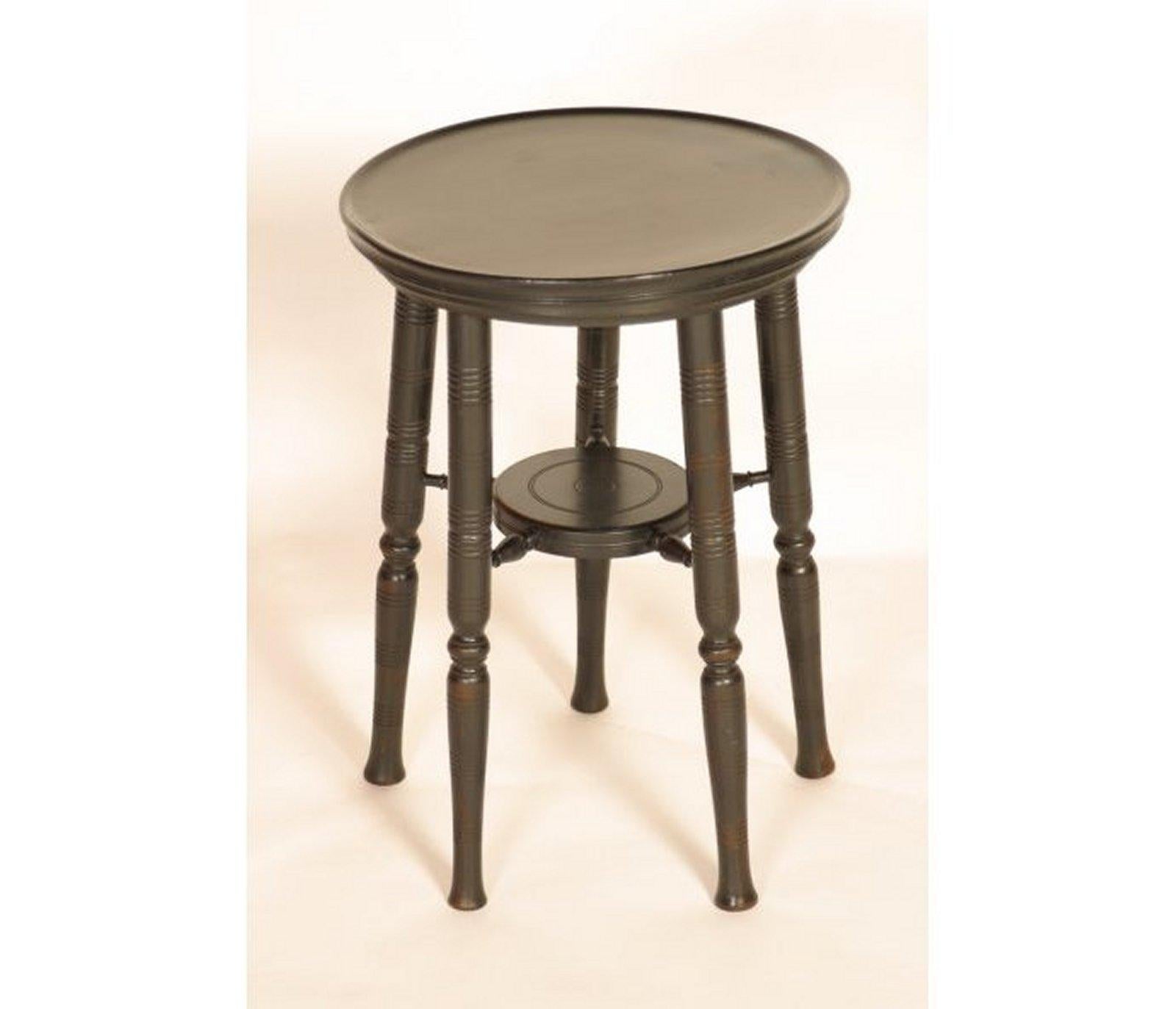 Edward William Godwin (attributed), an aesthetic movement circular wine table, the five turned legs united by a circular under tier.
The legs of this table are identical to those of the ebonized side tables that were made by William Watt. The use of