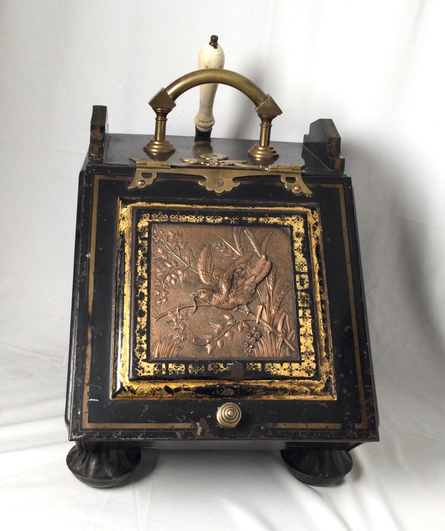 Ebonized tin, copper and brass coal scuttle, London by H. Loveridge, 1870s The model is the Edinburg featuring a high relief copper panel of a bird on a limb surrounded by leaves, tall grasses with a beautiful brass handle, hinges and its original