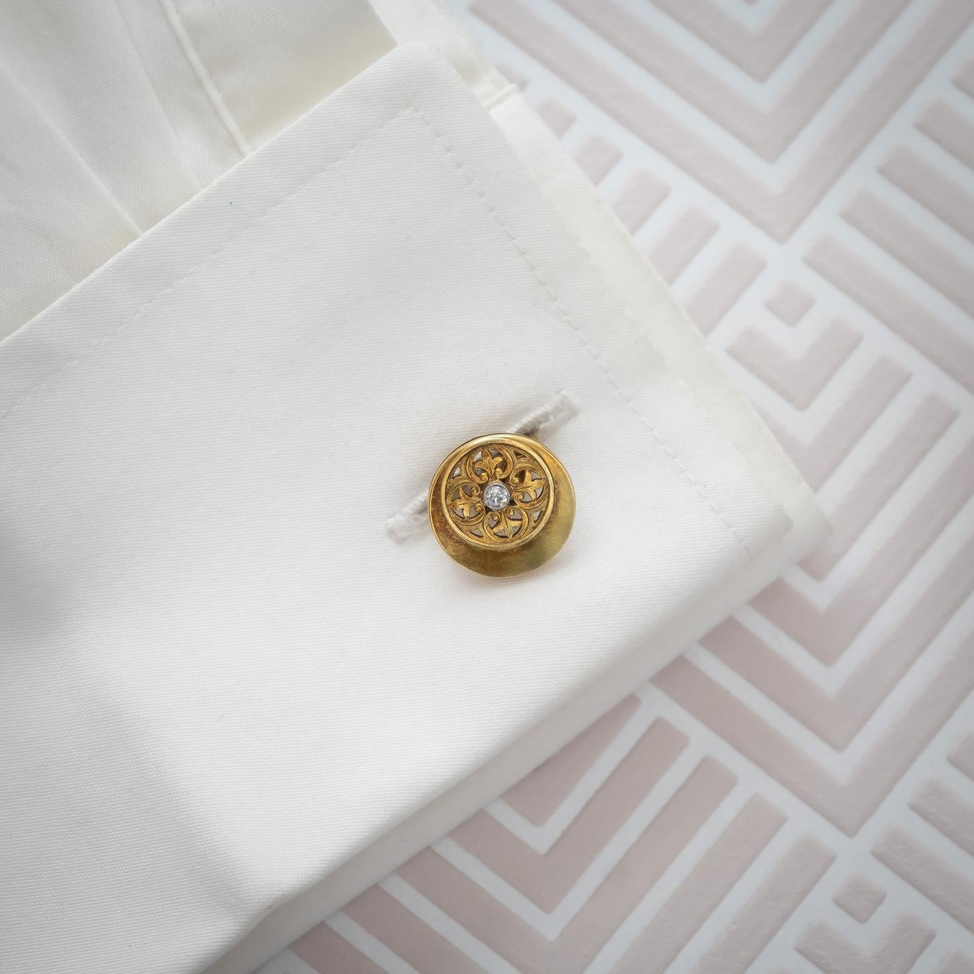 A pair of Victorian, Aesthetic Movement or Gothic Revival, gold and diamond cufflinks, with a motif, in the style of Pugin, within a crescent.