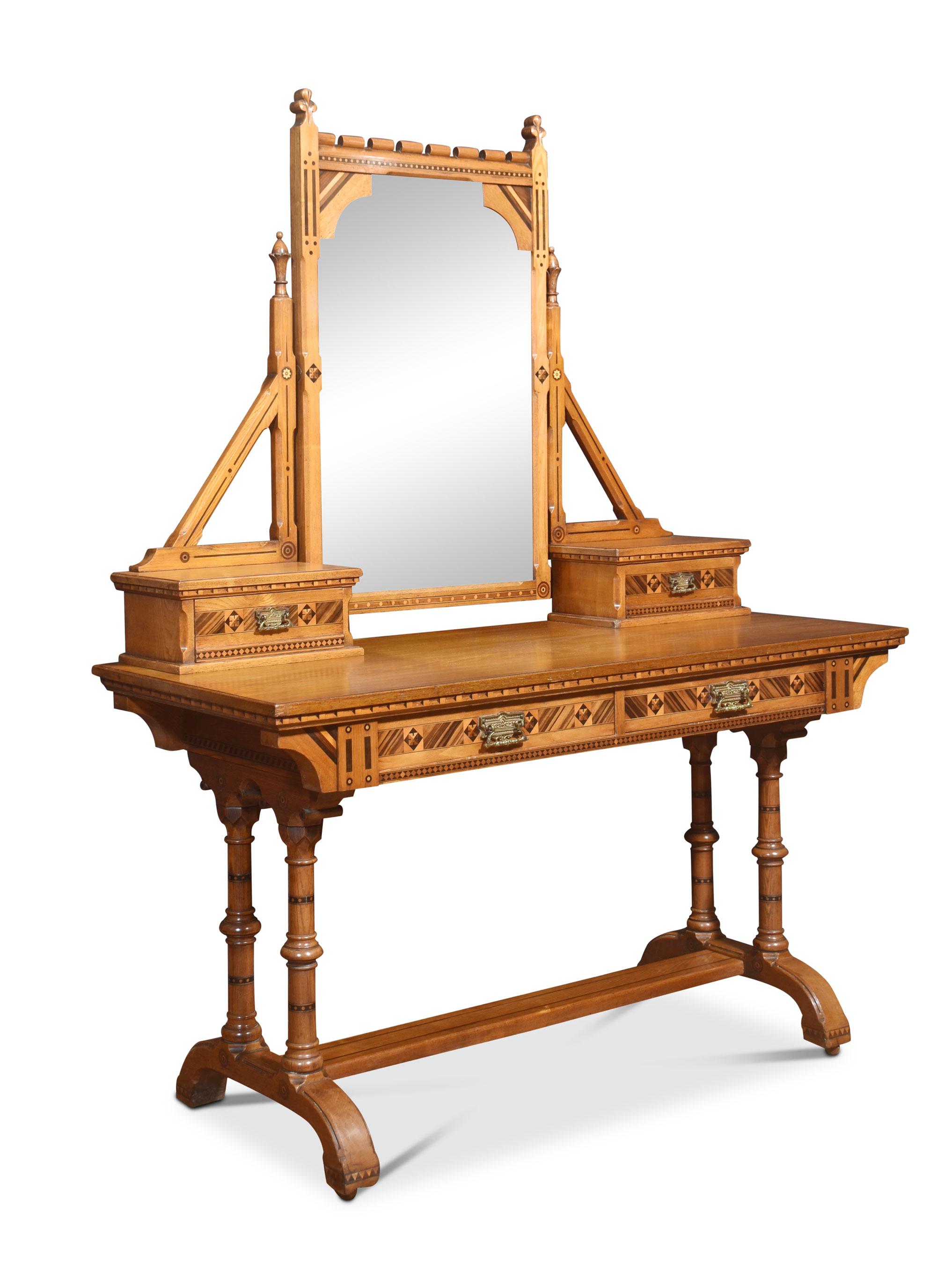 Aesthetic movement ash dressing table with ebonised detail. The central adjustable mirror supported on architectural supports above short drawers. To the rectangular top with inlaid frieze having two drawers with stylised brass handles. All raised