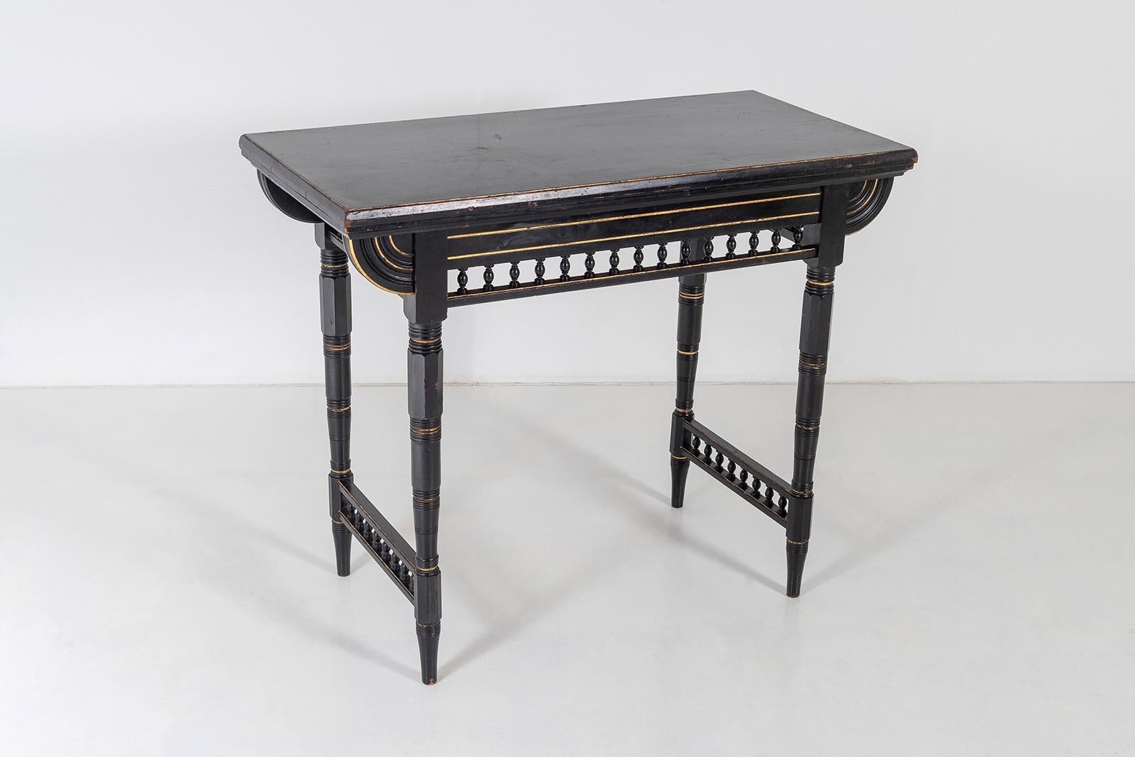 A superb little Aesthetic Movement Card Table that also makes a perfect Console Table.  In black mahogany ebonised and gilt finish with it original red baize inset top.
This piece contains so many wonderful detailing, the gallery border detail is
