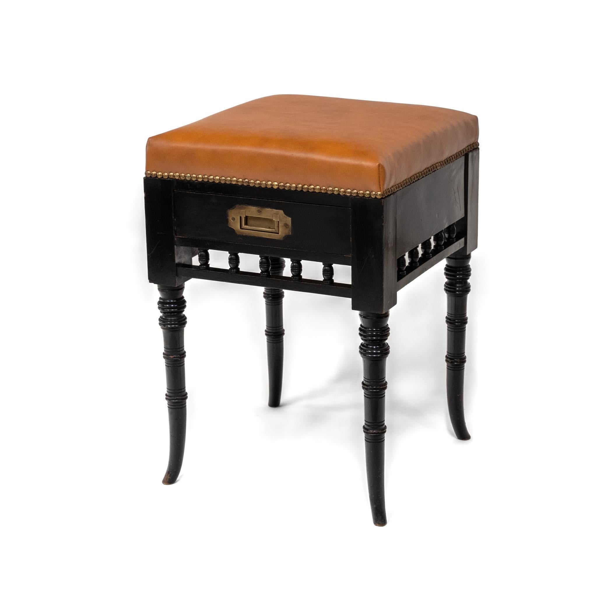 Aesthetic Movement ebonised & leather piano stool, with drawer. English. Circa 1880.

The stool has been reupholstered and covered in a 'super luxury' leather from Muirhead, which is Cinnamon in colour, with a matt finish. The leather showing some