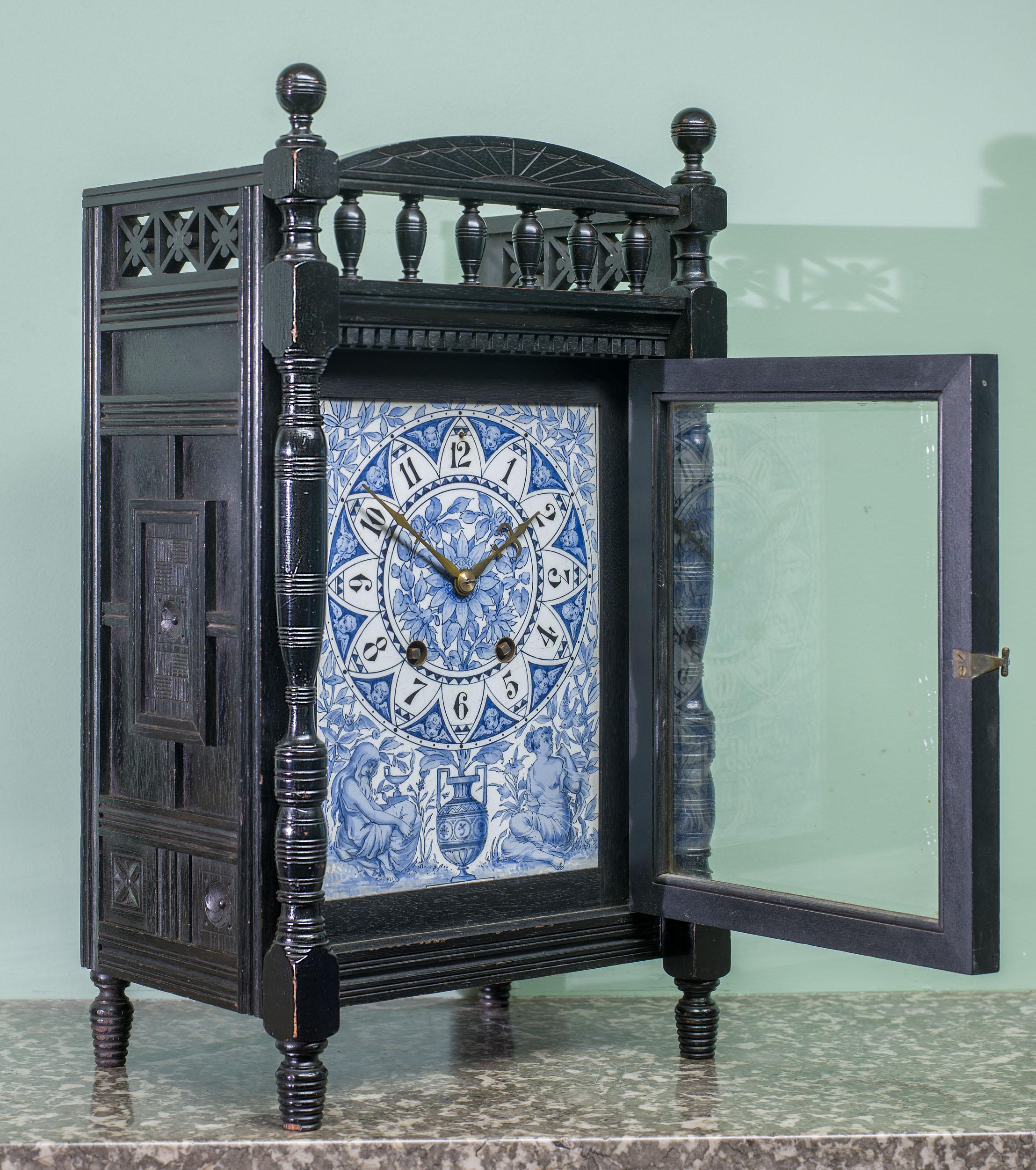 A magnificent Aesthetic Movement mantel clock, with an ebonised mahogany case and an exquisitely painted dial. The case embodies the style of the Aesthetic Movement, with an arched and turned gallery, surmounted by two turned ball finials, with a