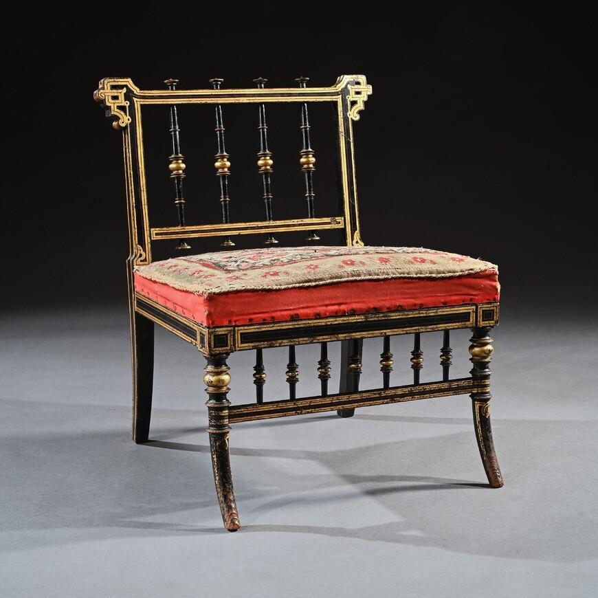 A wonderful example of a fine 19th century Aesthetic Movement ebonised slipper chair with original needle work upholstery, offered in untouched original condition.

English 1880.

Ebonised throughout, decorated with gilt bands and red lines, the