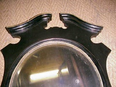 An Aesthetic Movement Ebonized and Gilt Mirror with Brass Candle Sconces