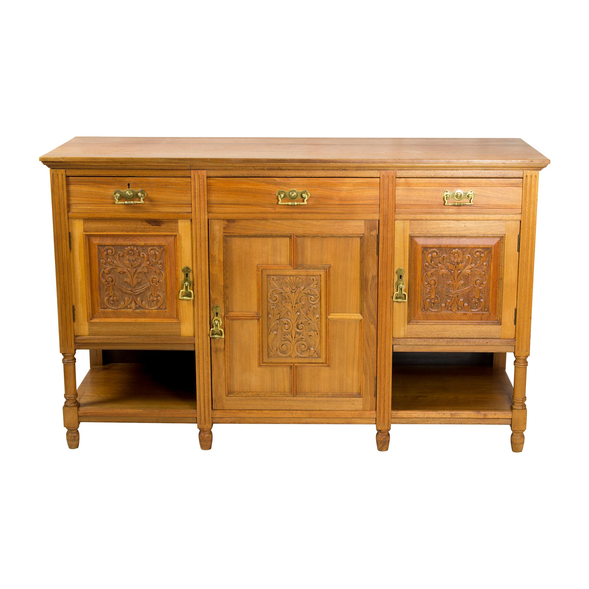 The sideboard comes from England from the late 19th century, it was built from English walnut in the course of the Aesthetic Movement. The fittings are made of brass, the doors open by turning the handles, keys are not provided. 
The sideboard has