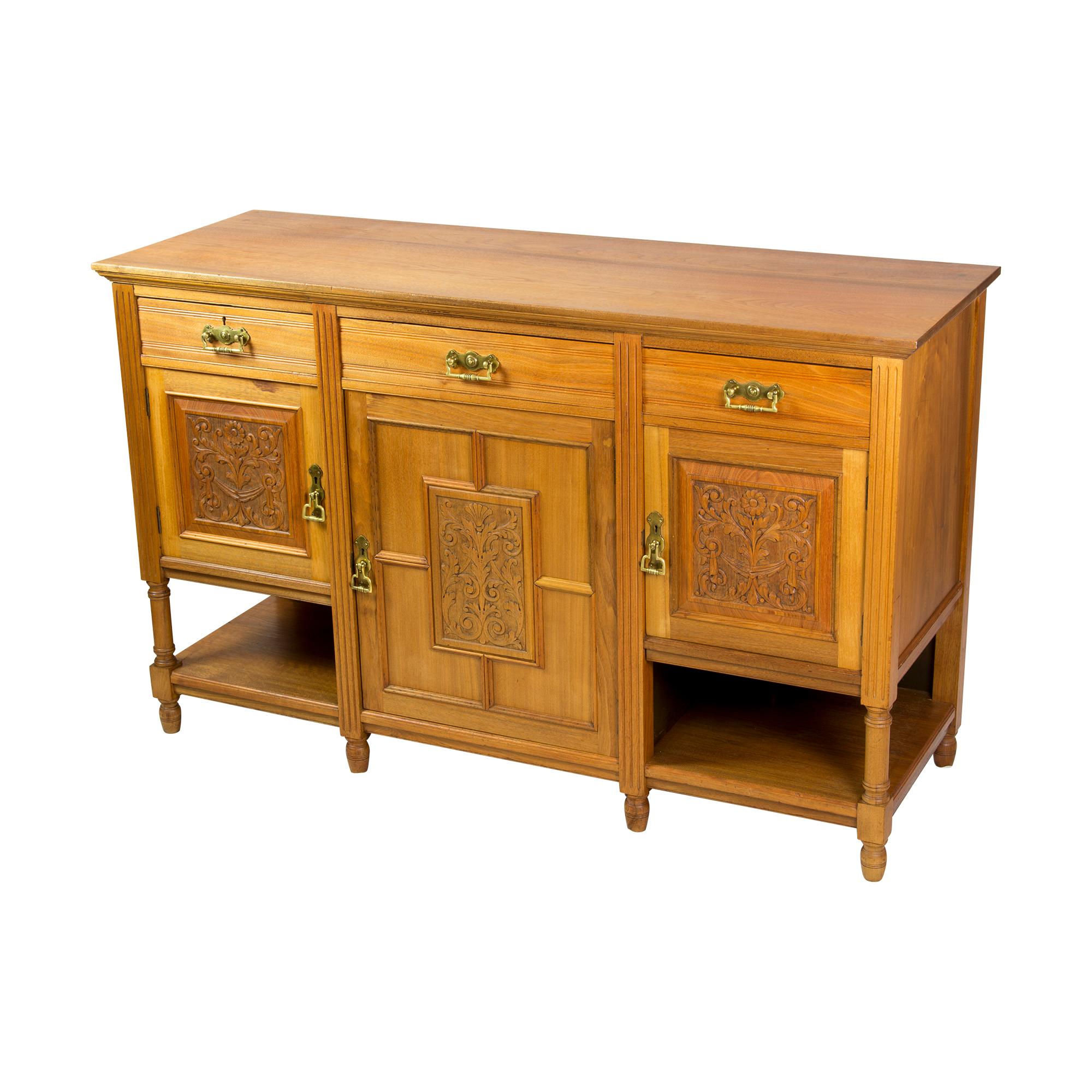 The sideboard comes from England from the late 19th century, it was built from English walnut in the course of the Aesthetic Movement. The fittings are made of brass, the doors open by turning the handles, keys are not provided. 
The sideboard has