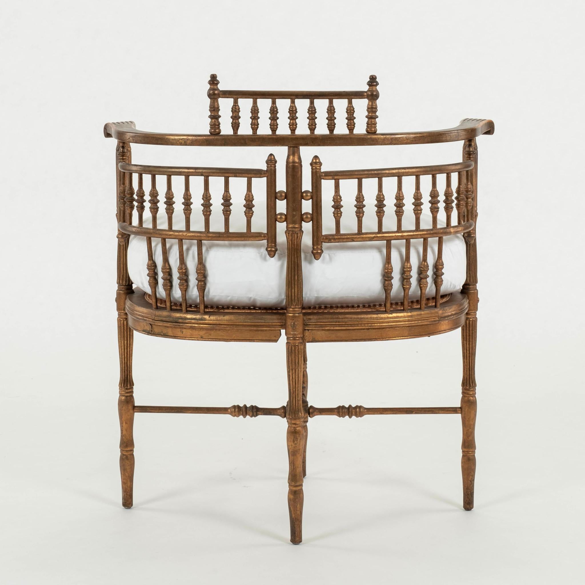 19th Century giltwood chair with wonderful hand carved curved arms, turned spindle, finals, cane seat and new feather down seat cushion in ticking.

Also available C.O.M. (additional $145.00) with quick turnaround when you send us your fabric.