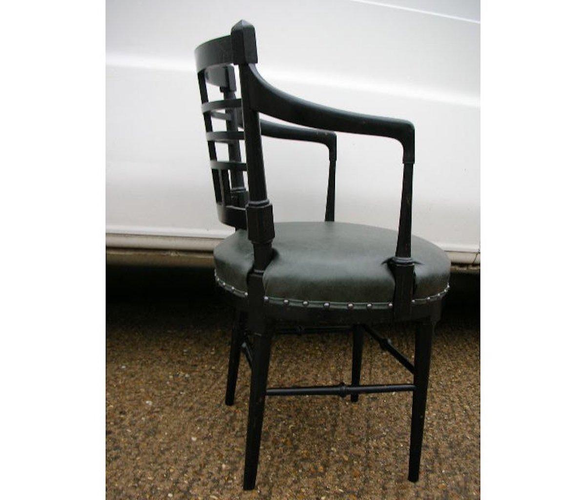 An Aesthetic Movement Jacobean or Old English ebonized armchair.
After a design by E. W. Godwin.
Probably made by C J Plunkett & Co. See The Secular Furniture of E W Godwin by Susan Weber Soros page 256.
Professionally reupholstered in quality