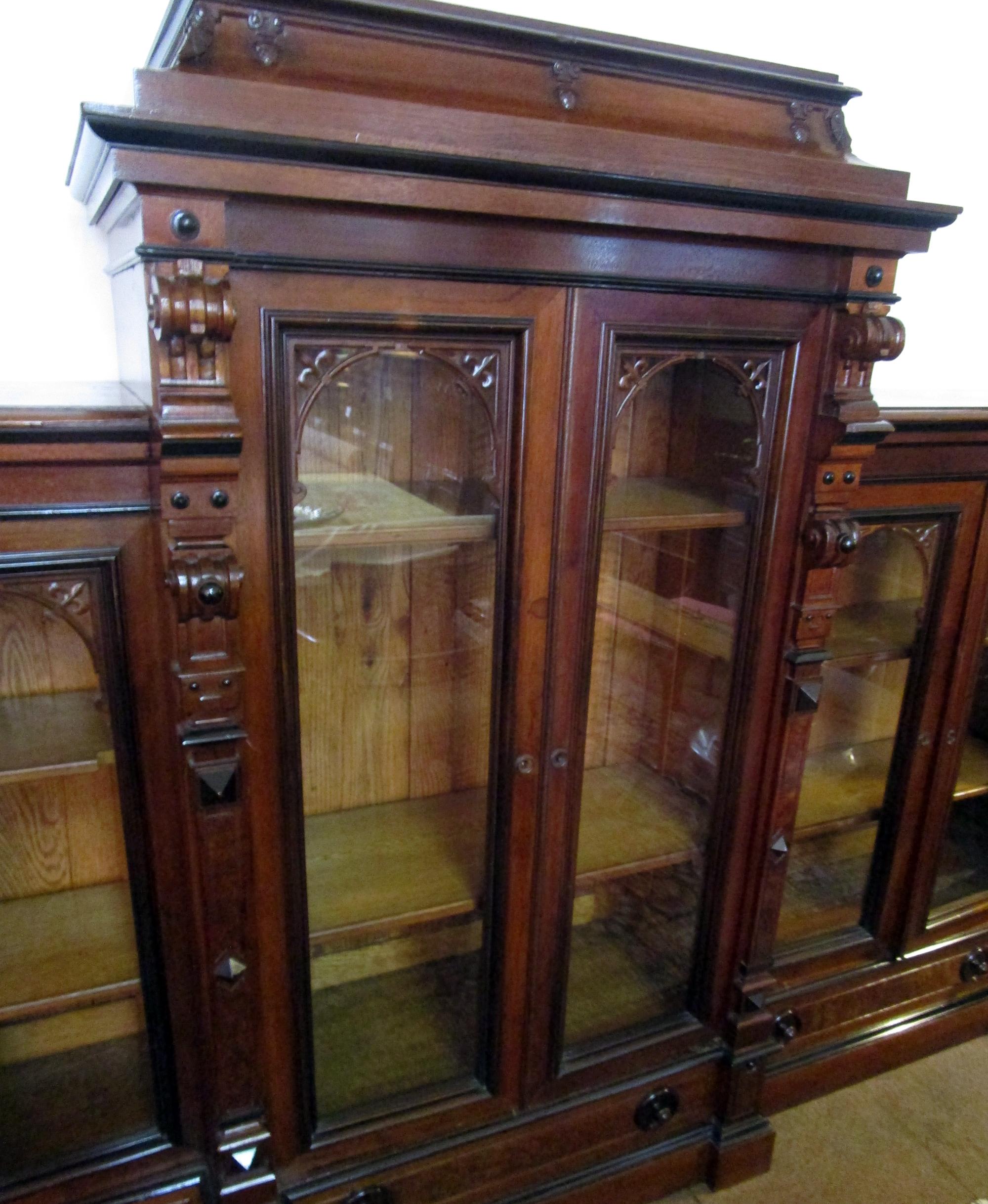 It is very unusual to find a matched pair of signed Herter Brothers bookcases, also extremely rare to find them in such a monumental size, each being eight feet nine inches wide, and in such good condition. Constructed in solid walnut with