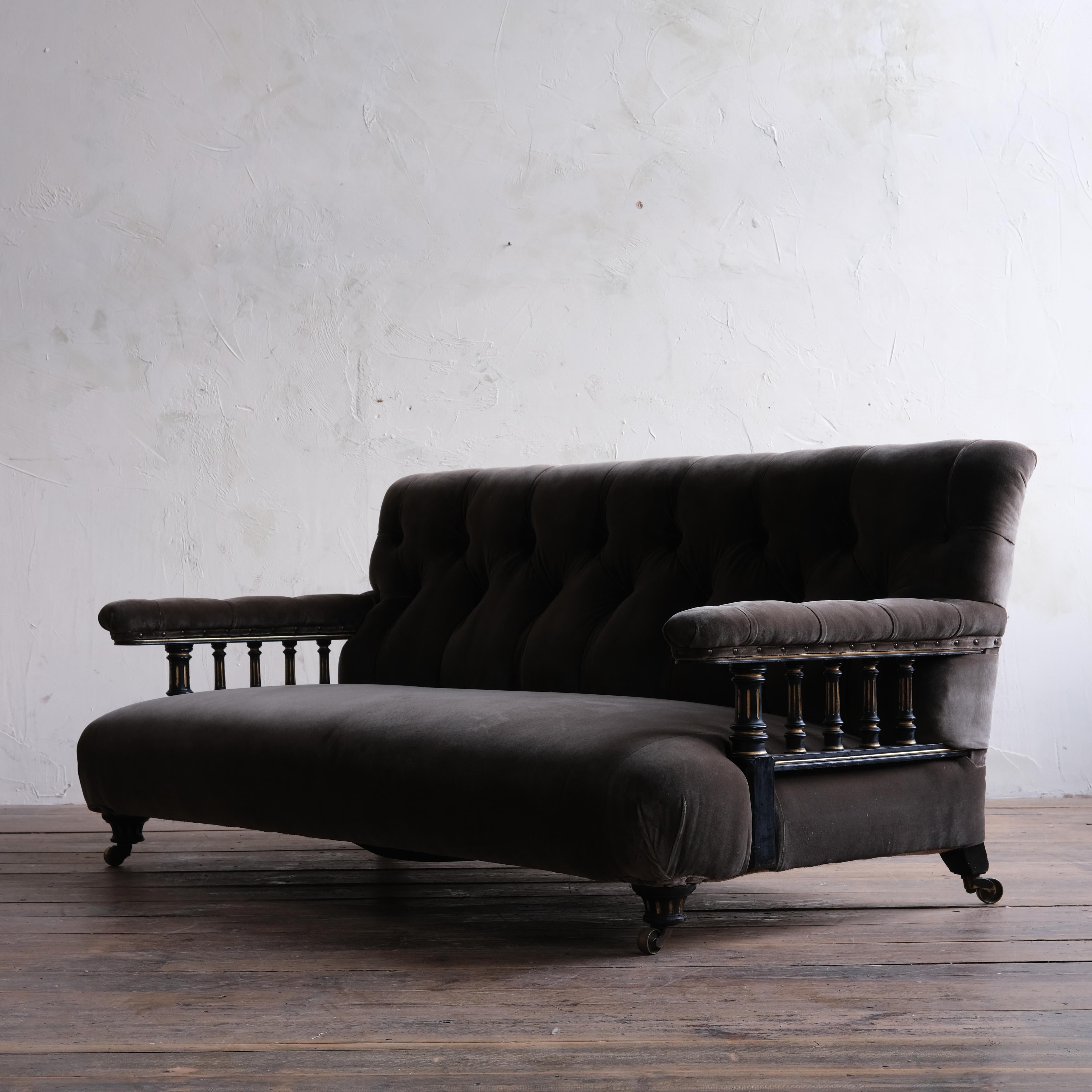 A superb 19th century open arm sofa almost certainly by Howard and sons. Upholstered in Rose Uniacke teddy cotton velvet and raised on ebonised and gilt walnut legs and arm supports. Retaining its original Cope and Collinson Brass casters. The