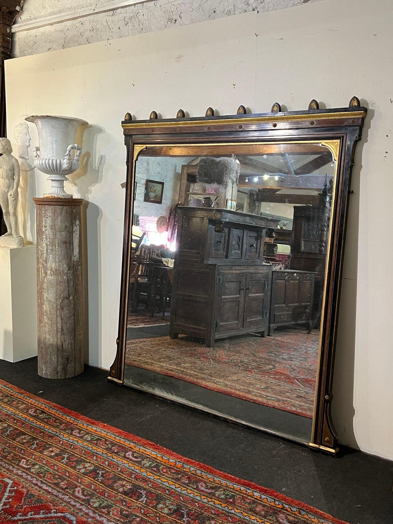A large and impressive over mantle mirror, in the aesthetic taste by James Lamb of Manchester. C.1870 with a nice speckled original mirror plate. Dimensions H 193 W 176 D 7cm