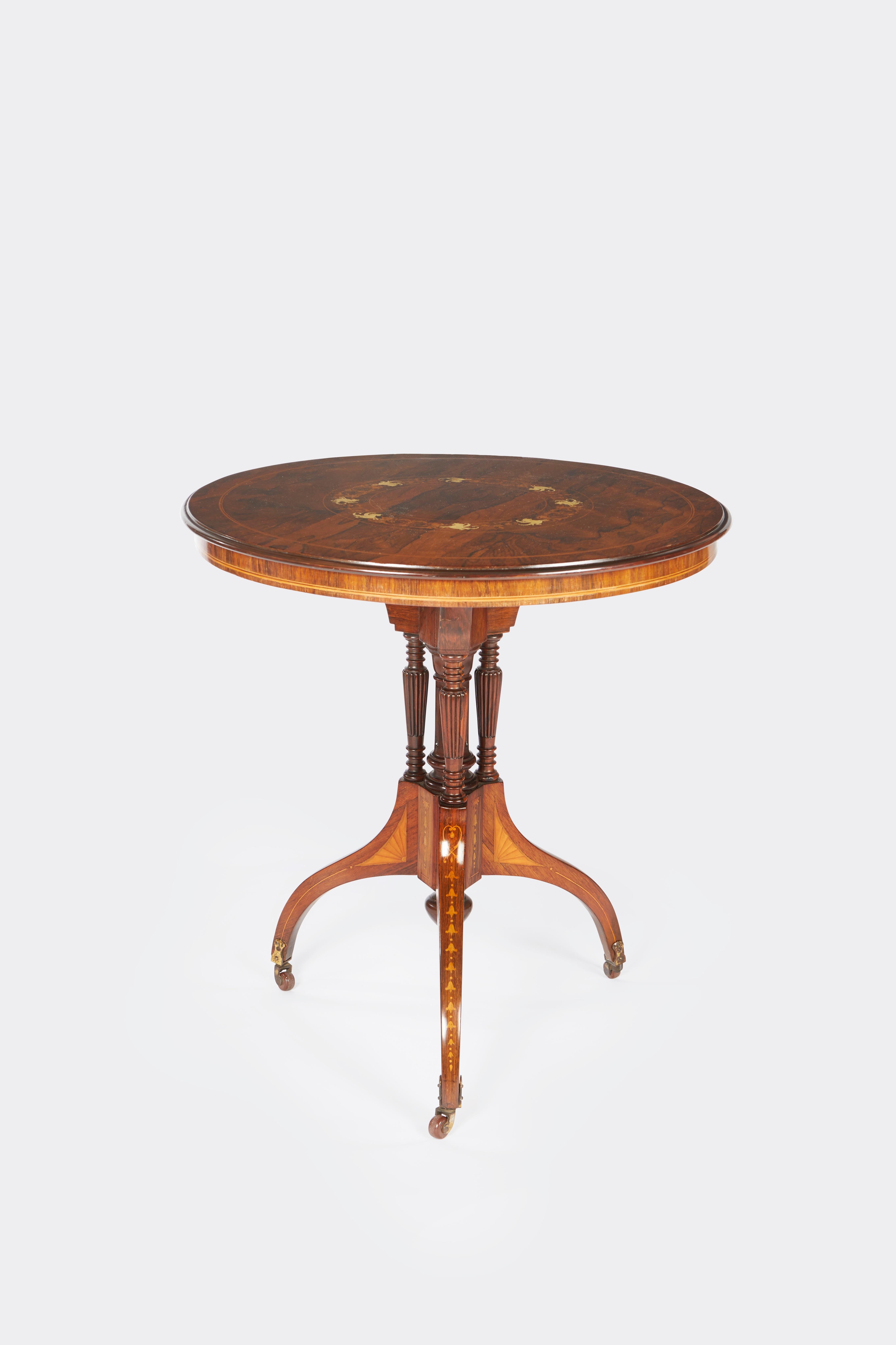 An American rosewood side table with a greek-inspired base the four legs with marquetry detail supported by baluster shaped elements. The highly figured rosewood veneered top having fine contrasting faux ivory inlay.