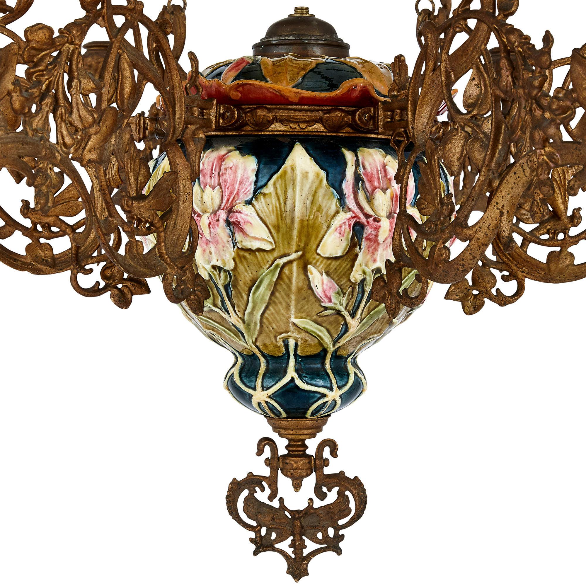 Aesthetic Movement spelter and majolica six-light chandelier,
French, early 20th century
Height 120cm, diameter 74cm

This beautiful chandelier, which demonstrates some of the taste of the Aesthetic Movement as well as Art Nouveau, is crafted