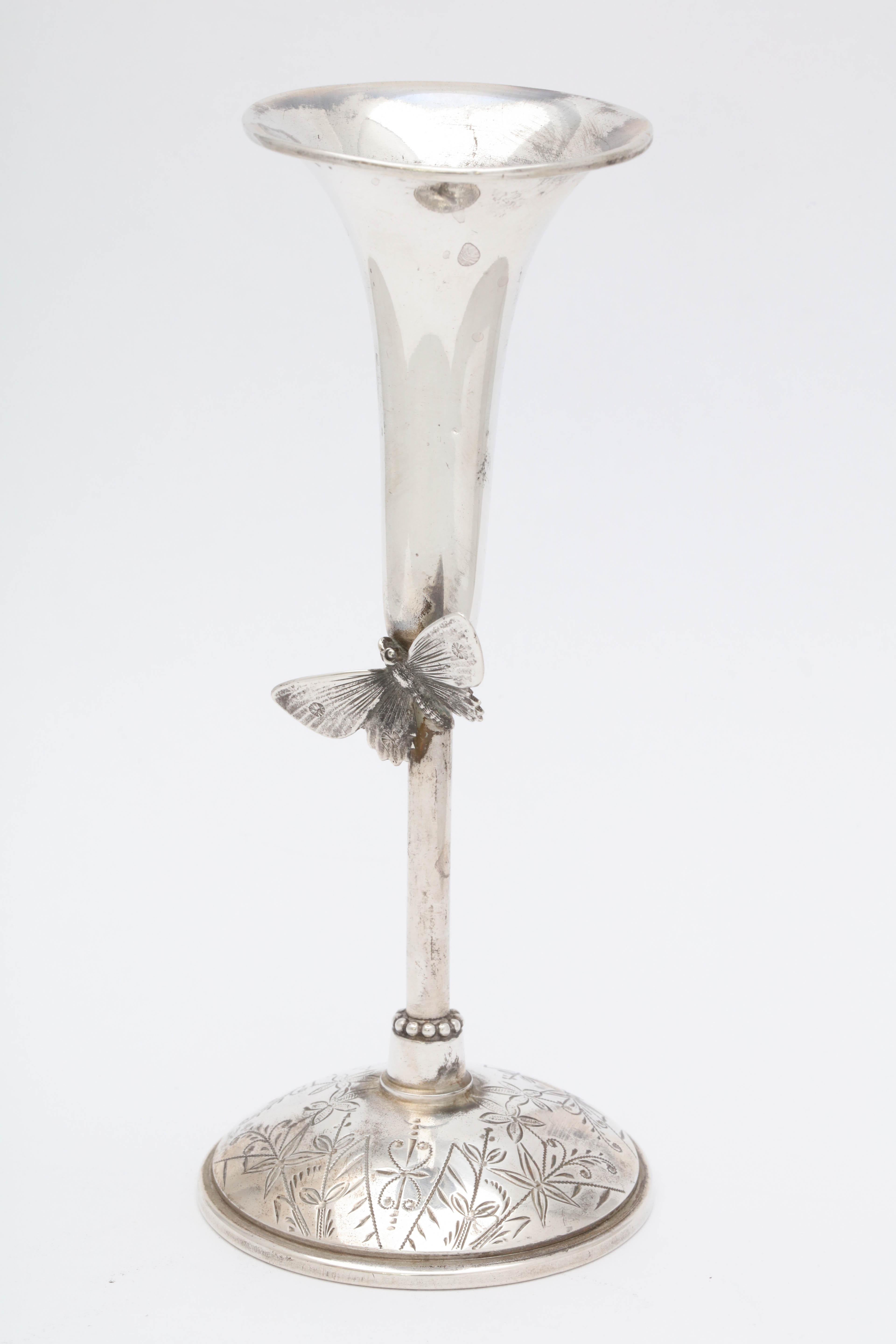 Aesthetic Movement, sterling silver bud vase, Wood and Hughes Co., New York, circa 1875. An applied butterfly decorates the stem. Etched work on base. Measures 5 1/2 inches high x 2 1/4 inches in diameter across base x 2 inches in diameter across