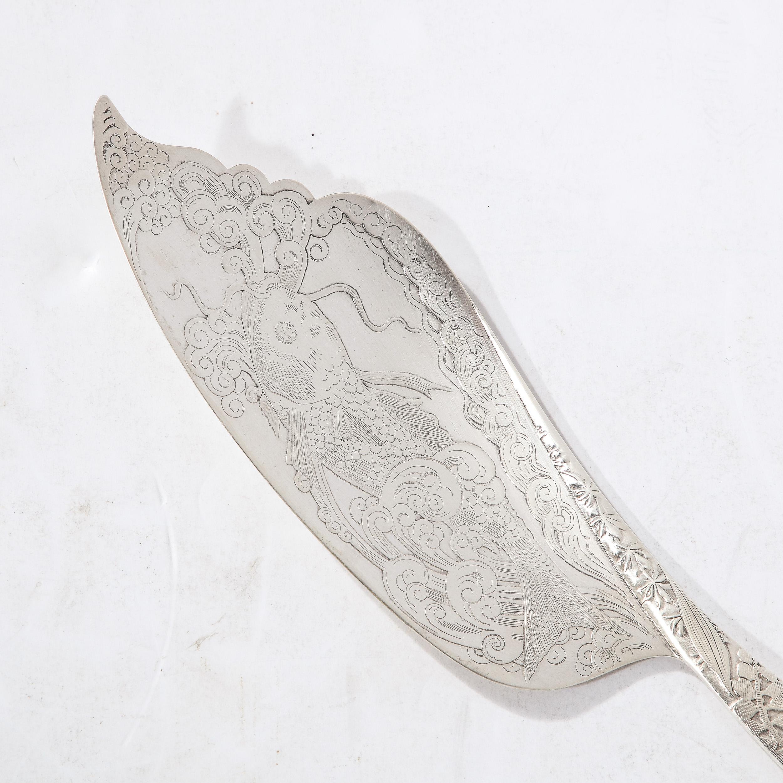This elegant and well adorned Sterling Silver Fish Slice W/Acid Etched & Hand Tooled Detailing is crafted by the Whiting Manufacturing Company and originates from the United States, Circa 1890. This piece features a minimal profile of elegant