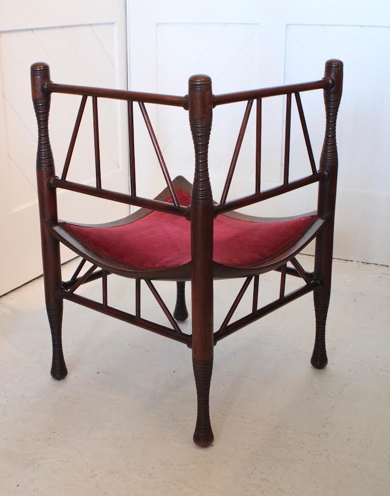 Aesthetic Movement rare ‘Thebes’ walnut corner chair
Red velvet seat
By Liberty & Co
Circa 1885.
 