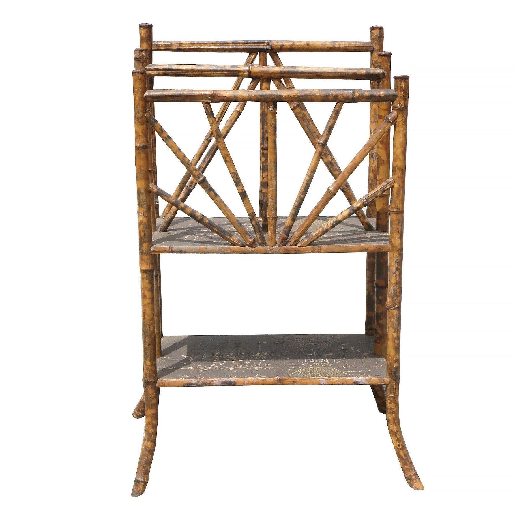 Antique Aesthetic Movement tiger bamboo magazine rack with divider and bottom shelf. The rack features a unique Art Nouveau relief along the top of each tier on the self.

1900, United States

We only purchase and sell only the best and finest