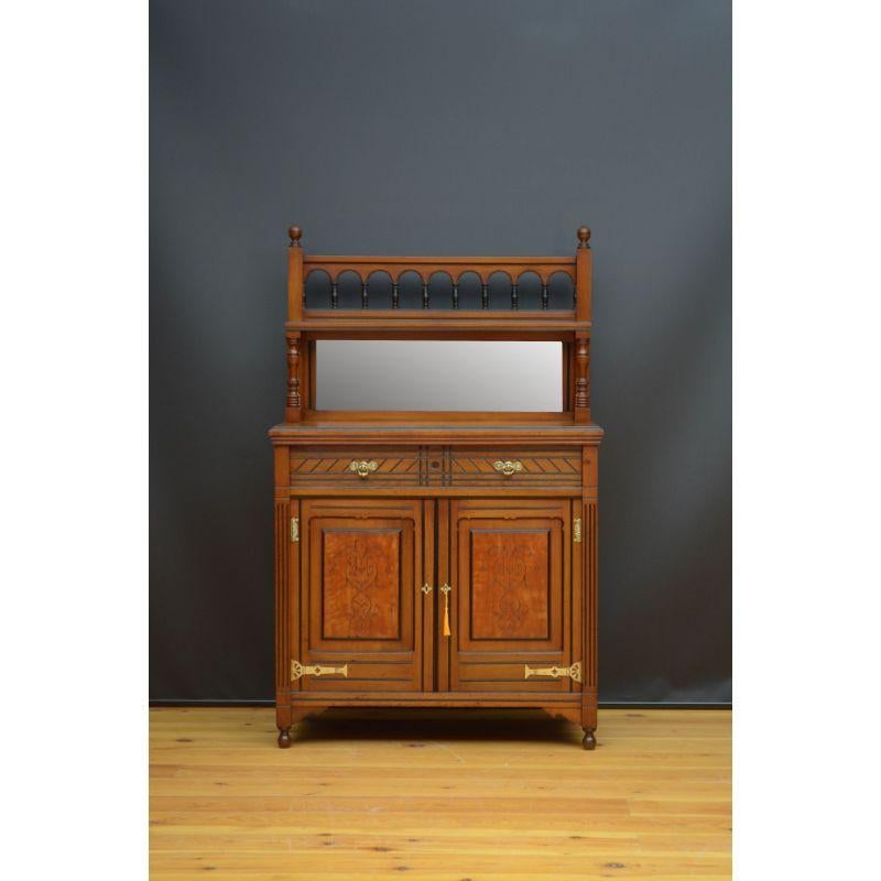 Sn5162 ~Stylish Aesthetic Movement walnut chiffonier, having mirrored back with arched gallery supported on ebonised spindles above figured walnut top above a frieze drawer and a pair of satinwood panelled cupboard doors, all fitted with original