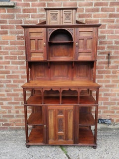 Aesthetic Movement Walnut Cabinet of Architectural Form with Carved Decoration.