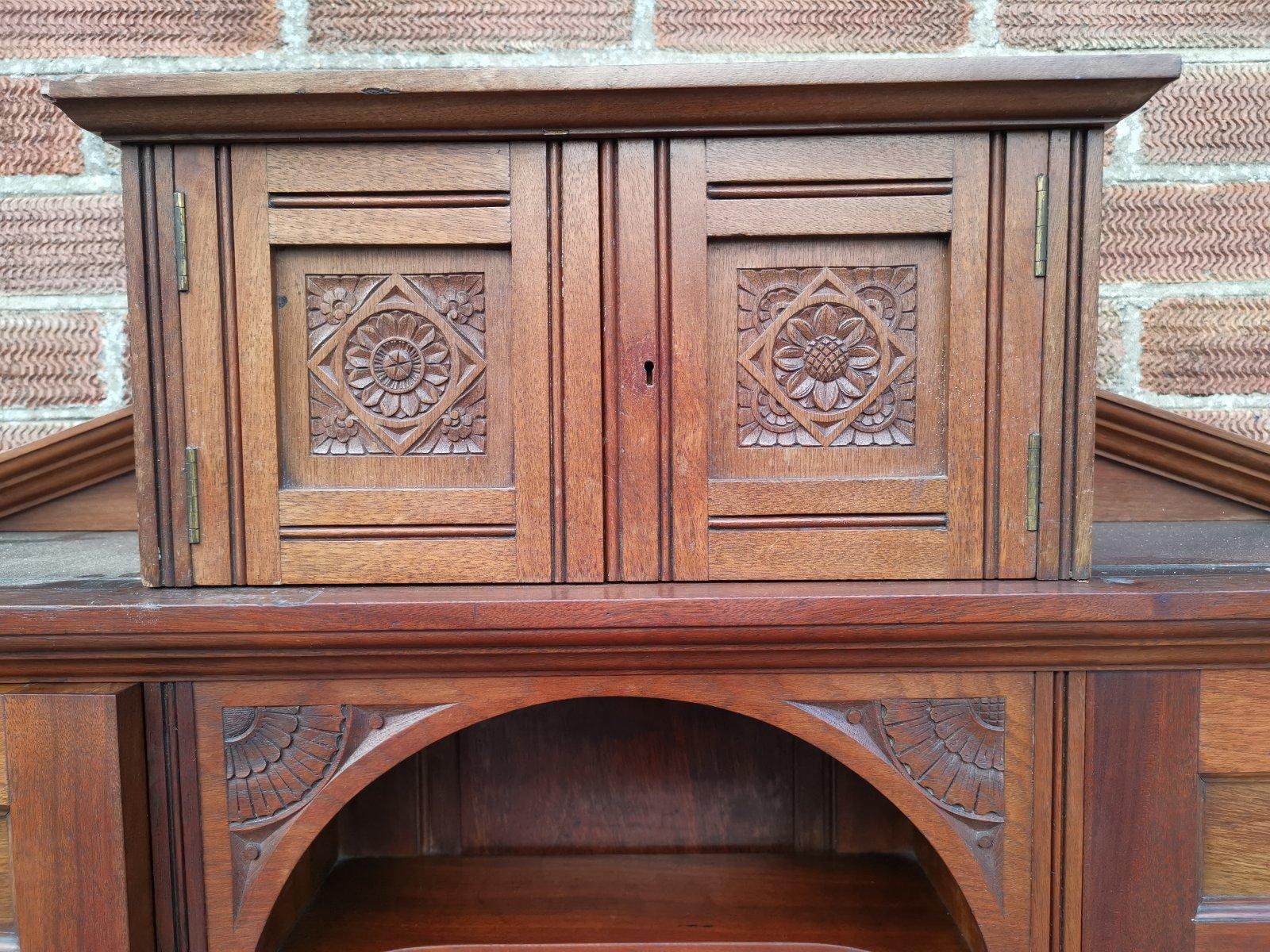 Aesthetic Movement Walnut Cabinet of Architectural Form with Carved Decoration. In Good Condition For Sale In London, GB