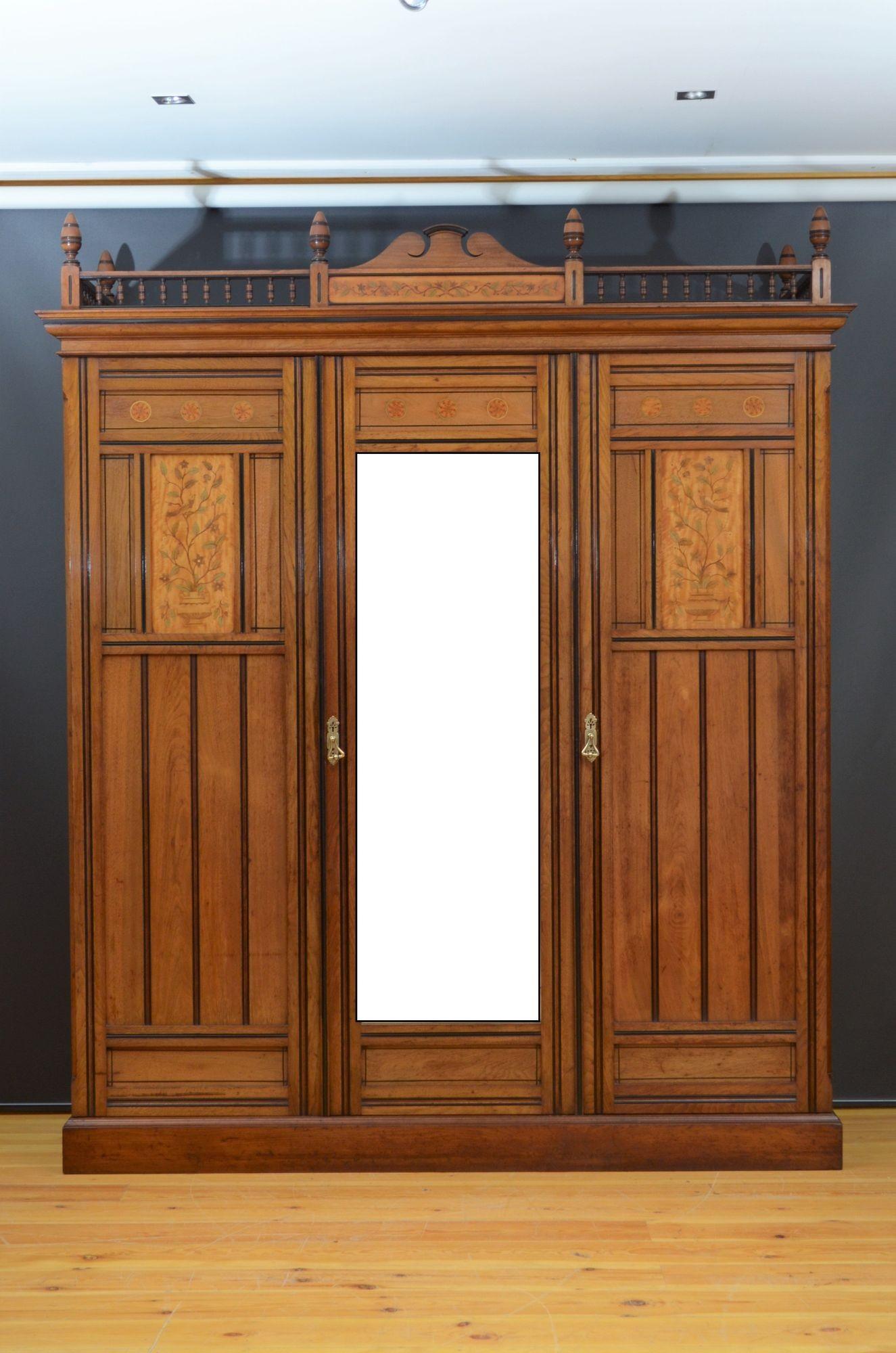 Sn5441 Superb Victorian three door wardrobe, having swan neck pediment with inlaid panel flanked by reeded spindles to the top ( the top gallery is optional and can be unscrewed) above mirrored centre door with satinwood inlaid panel flanked by