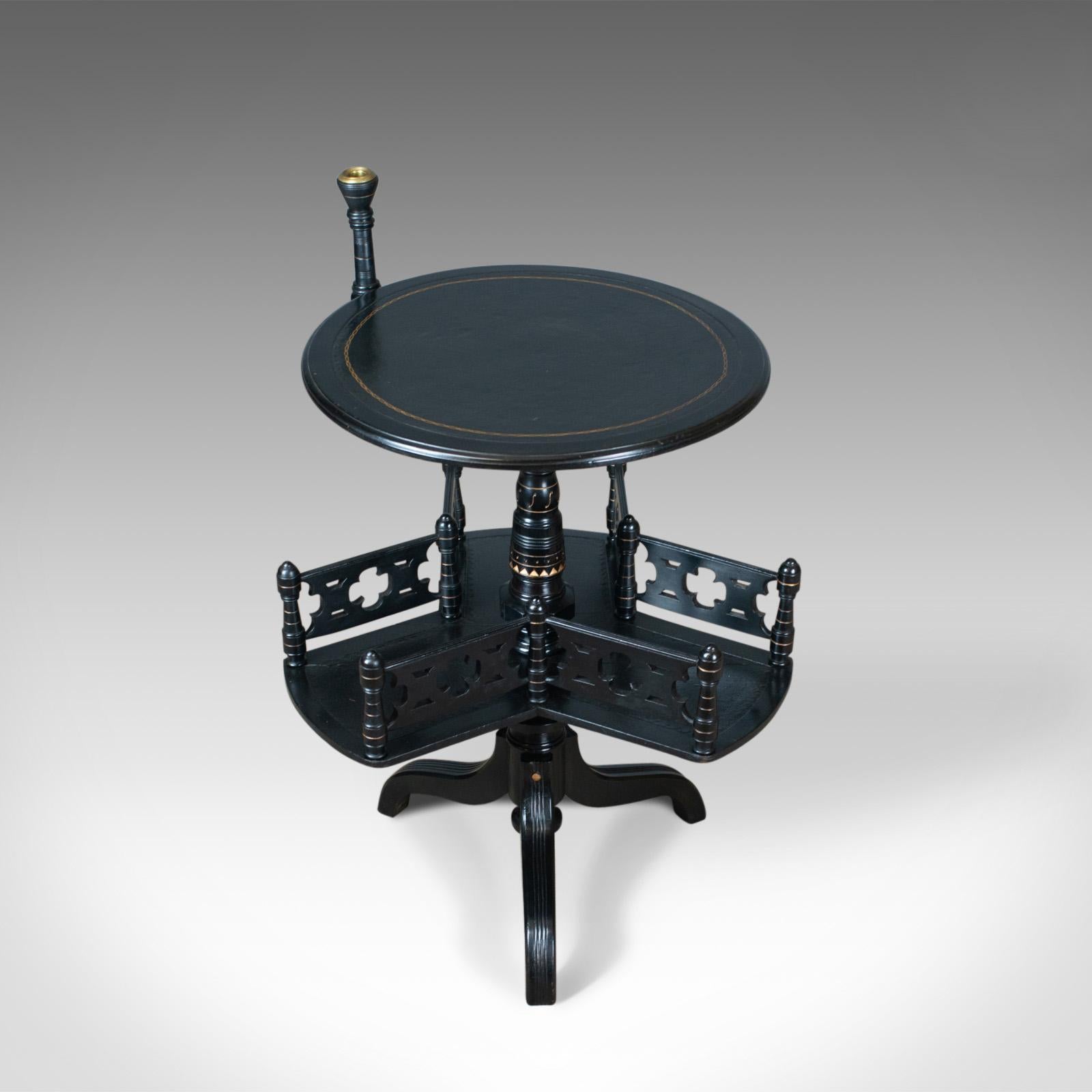 This is an aesthetic period reading table, an English, Victorian ebonised side table with rotating bookshelf and candle stand dating to the late 19th century, circa 1880.

Presenting well and in superb condition
Polished, ebonised finish