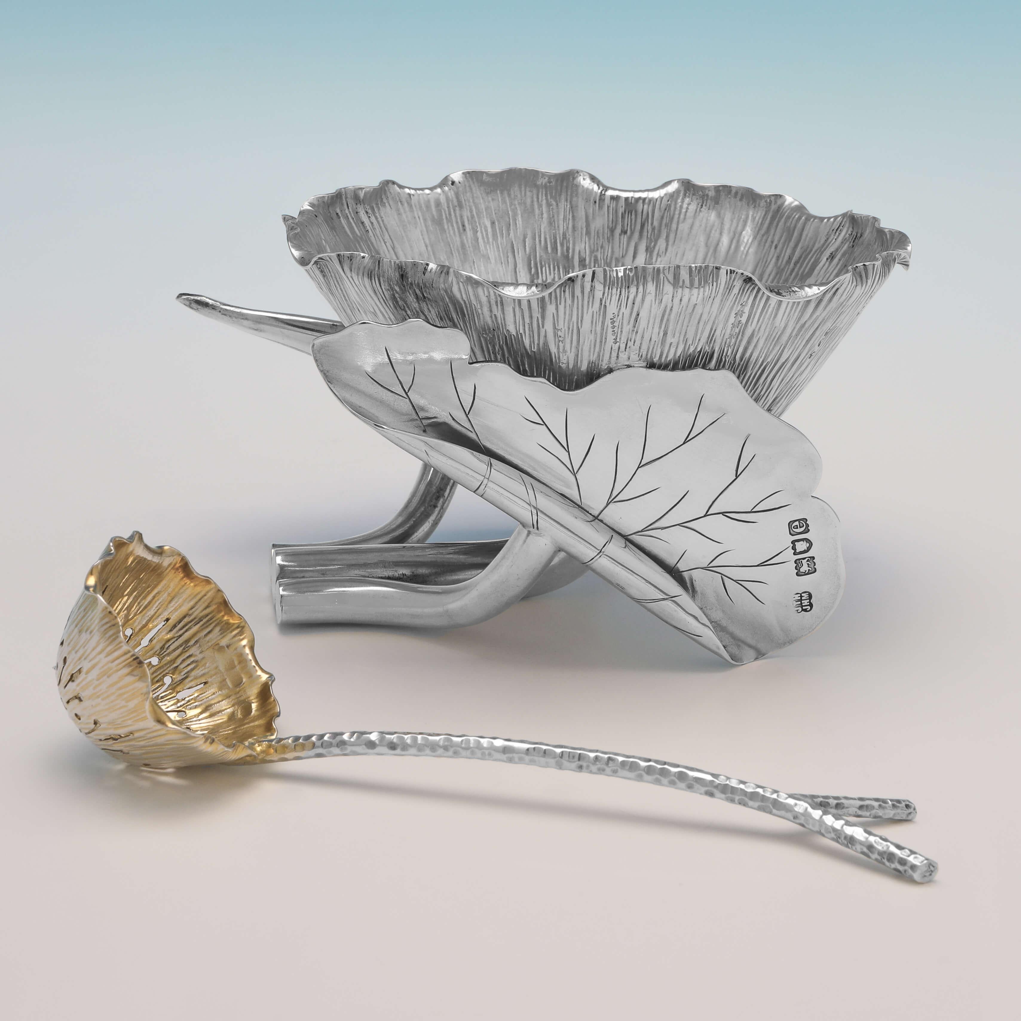 Hallmarked in London in 1900 by Heath & Middleton, this wonderfully designed Antique Sterling Silver Sugar Bowl, takes the form of a blossoming lotus flower, supported on the stems of two curled leaves, and accompanied by a sugar sifter spoon with a