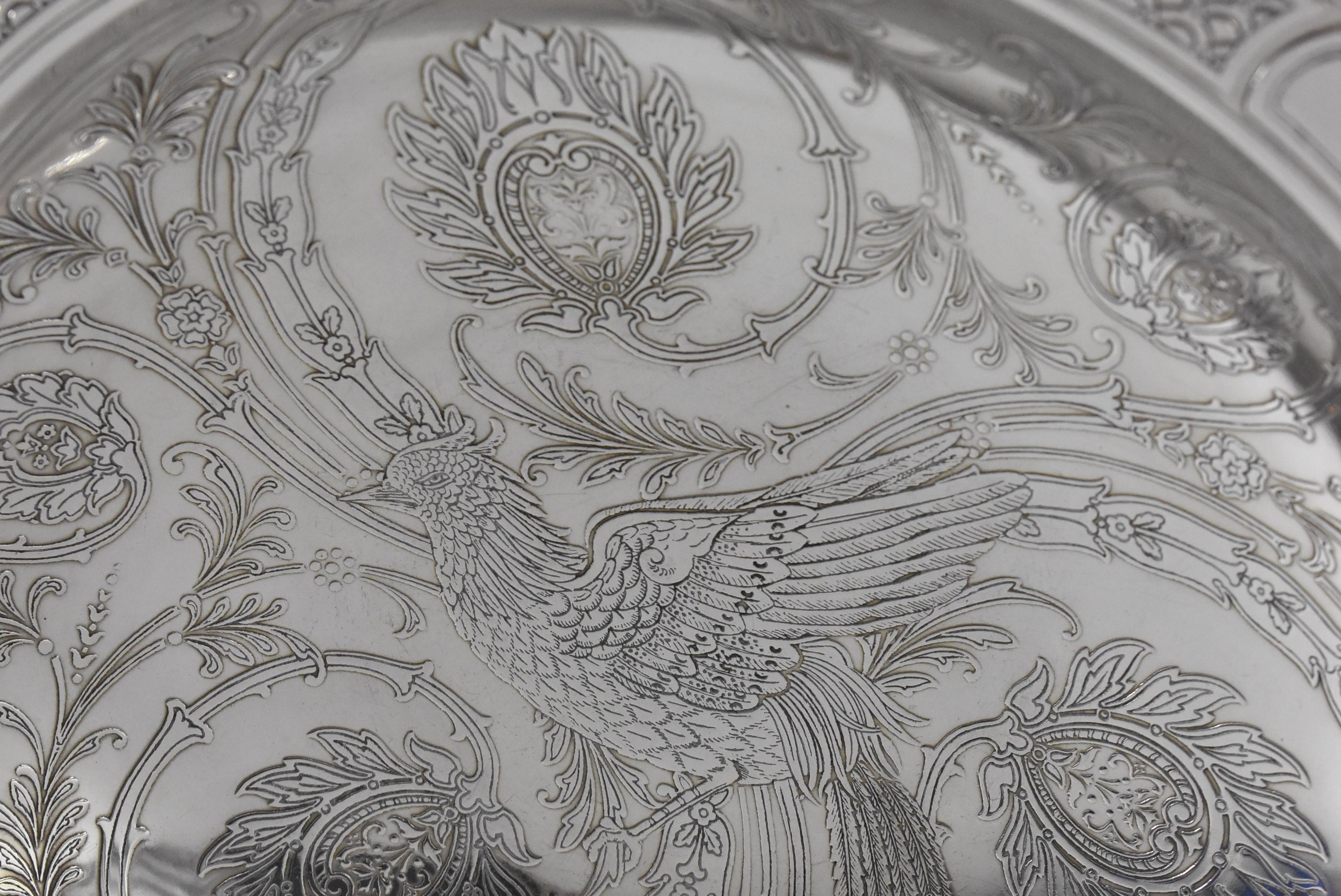 Aesthetic circa 1914 Tiffany & Co. sterling silver bowl with molded rim and foot. Acid etched interior patterned with bird and floral designs. Rim has fish tail details. Marked on the bottom 18696 A 925-1000 6499. No dings. Scratches on the bottom