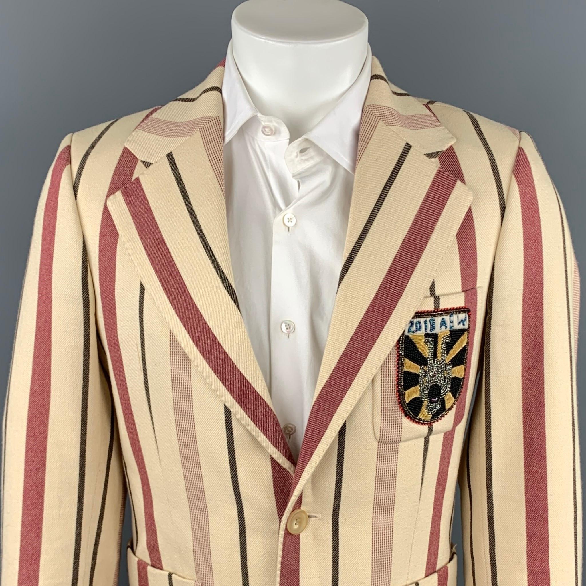 AESTHETICTERRORISTS by WALTER VAN BEIRENDONCK sport coat comes in a burgundy & cream vertical stripe wool with a full liner featuring a notch lapel, upside-down beaded patch, front pockets, and a double button closure.

Very Good Pre-Owned