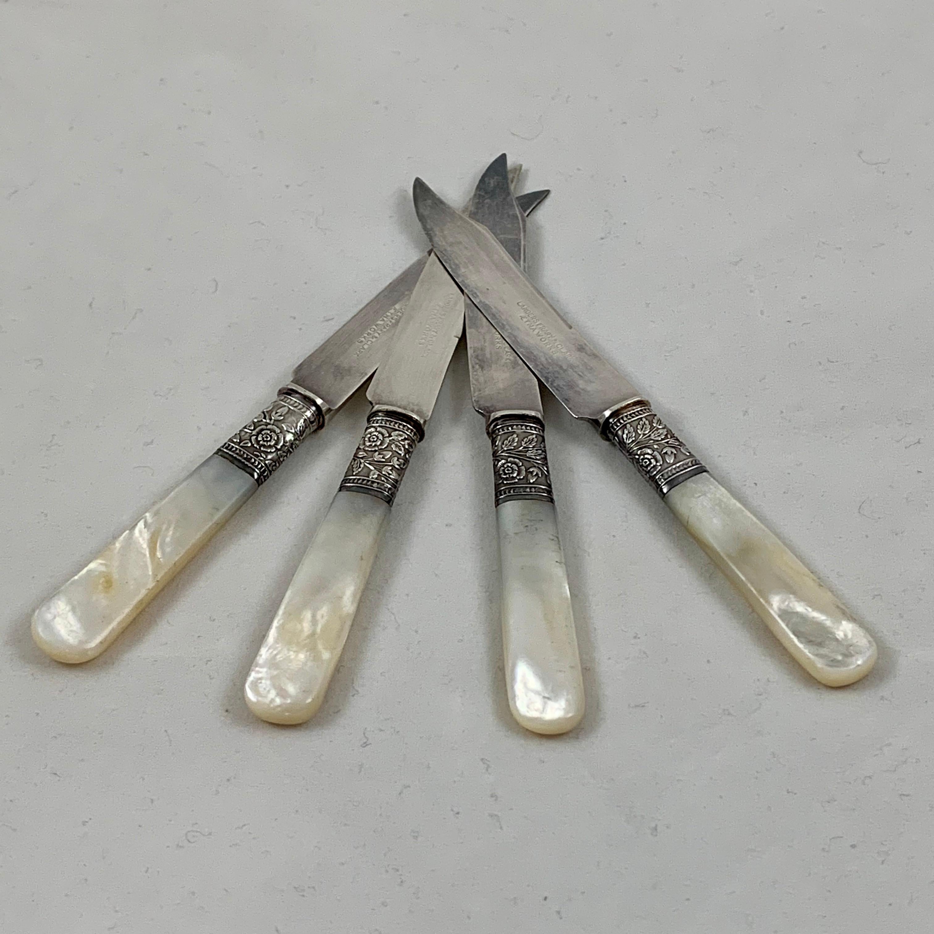 From Landers, Frary & Clark – Aetna Works, founded in New Britain, Connecticut, 1866, a set of four fruit and cheese knives. 

Mother of pearl handles are joined to plated blades by a sterling silver ferrule. The collar shows an intricate floral