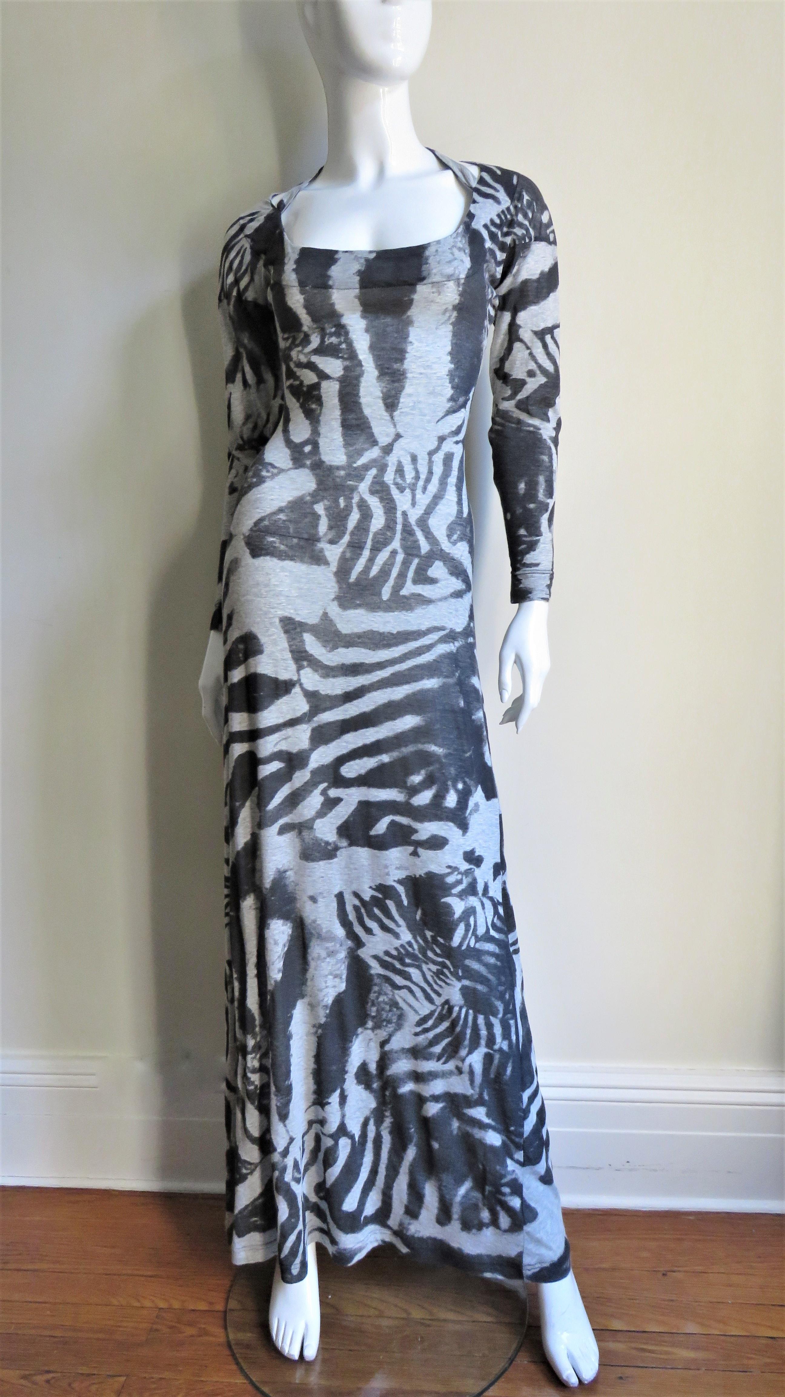 A fabulous maxi dress from Alexander McQueen in a fine cotton knit in an abstract pattern in shades of grey.  It is semi fitted to the hips then flares gently to the hem, slightly fuller in the back.  It has long sleeves, a scoop neck in the front