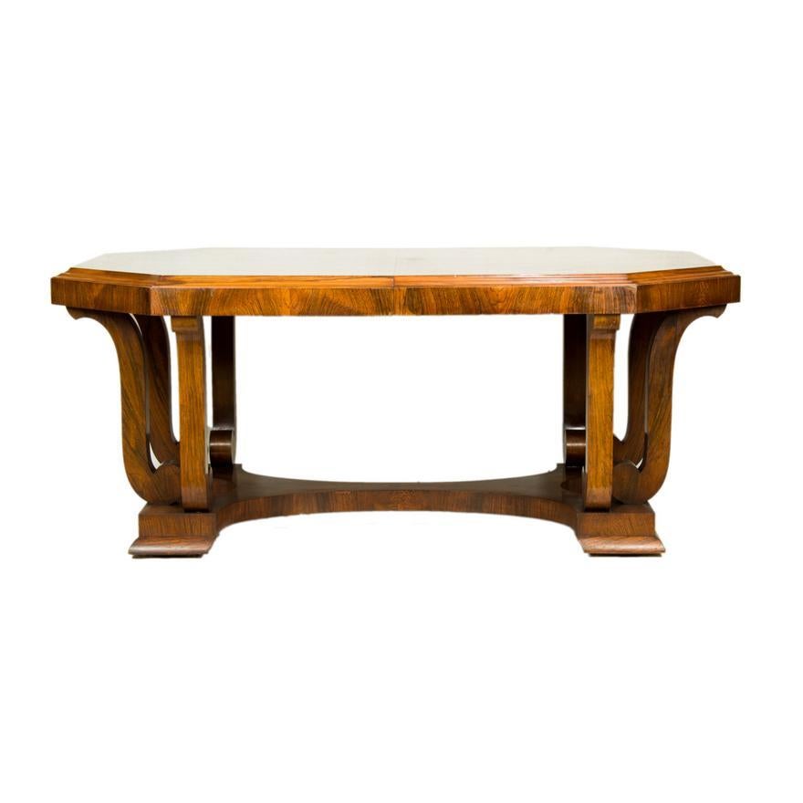 French Art Deco Rectangular Dining Table having an octagonal shaped top with a conforming apron, above the S form scrolled supports resting on the hourglass base 