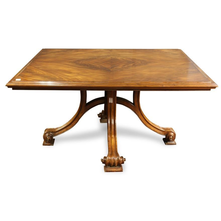 Late 20th Century French Provincial Style mahogany dining room table - the square form with a top highlighted by a book matched mahogany crotch veneer  above the hand carved and shaped mahogany pedestal base rising on carved and inswept legs,