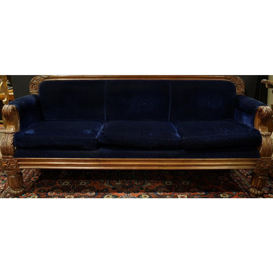 Very cool late Victorian Circa 1880 American made carved walnut sofa upholstered in a lustrous vintage blue mohair fabric having a carved floral crest above the three loose cushions, the arms with carved returns and rising on carved legs. In very