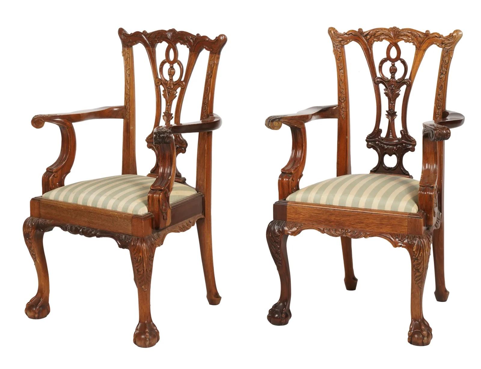 Pair of Early 20th Century Carved Mahogany Chippendale Style Child's Chair - each with a removable seat cushion. Intricate carving details throughout. Ball and claw carved feet.
