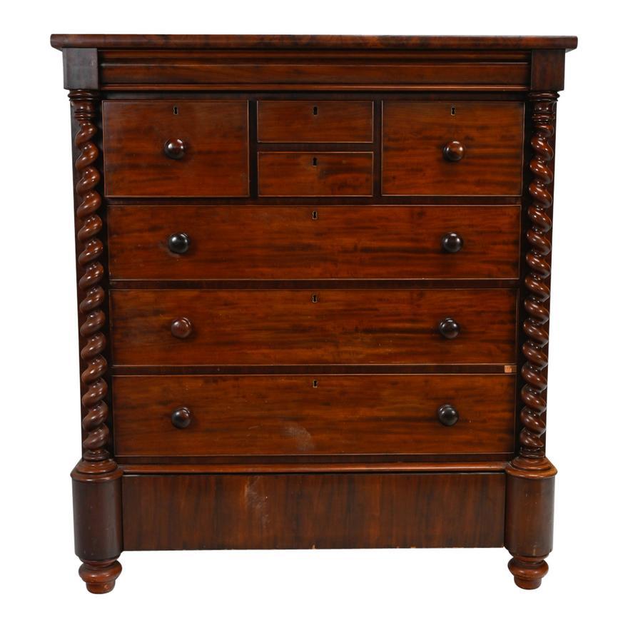 Circa 1820 New York Late Classical Flame Mahogany Gentleman's Dresser.  Single long drawer over four short drawers above four more long drawers, original  round wood pulls, flanking barley twist column supports, the top drawer with hidden latch to