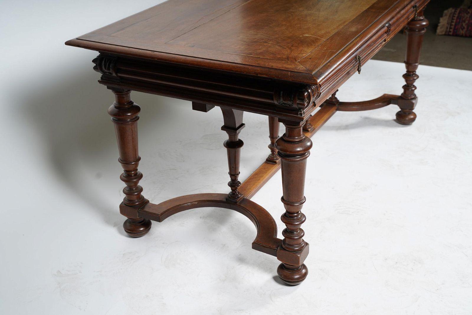 Beautifully maintained Circa 1860 American Victorian Walnut Library Table / Desk in the Renaissance Revival Style. Solid wood construction throughout. Two side by side deep drawers with central locking mechanism. 
