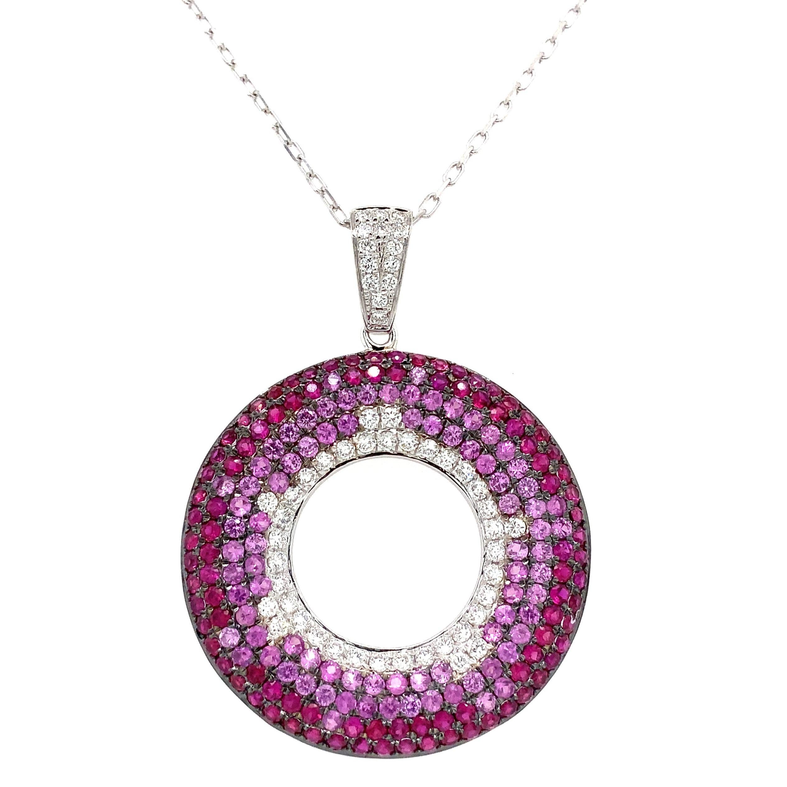This Afarin Collection Ambre Pavé Set boasts a feminine circle of life design with Pink Sapphire and Diamond accents set in 18K White Gold.
179 Round Ruby and Pink Sapphire =3.06 cts. total weight
53 Round Brilliant Cut Diamond = 0.60 ct. total