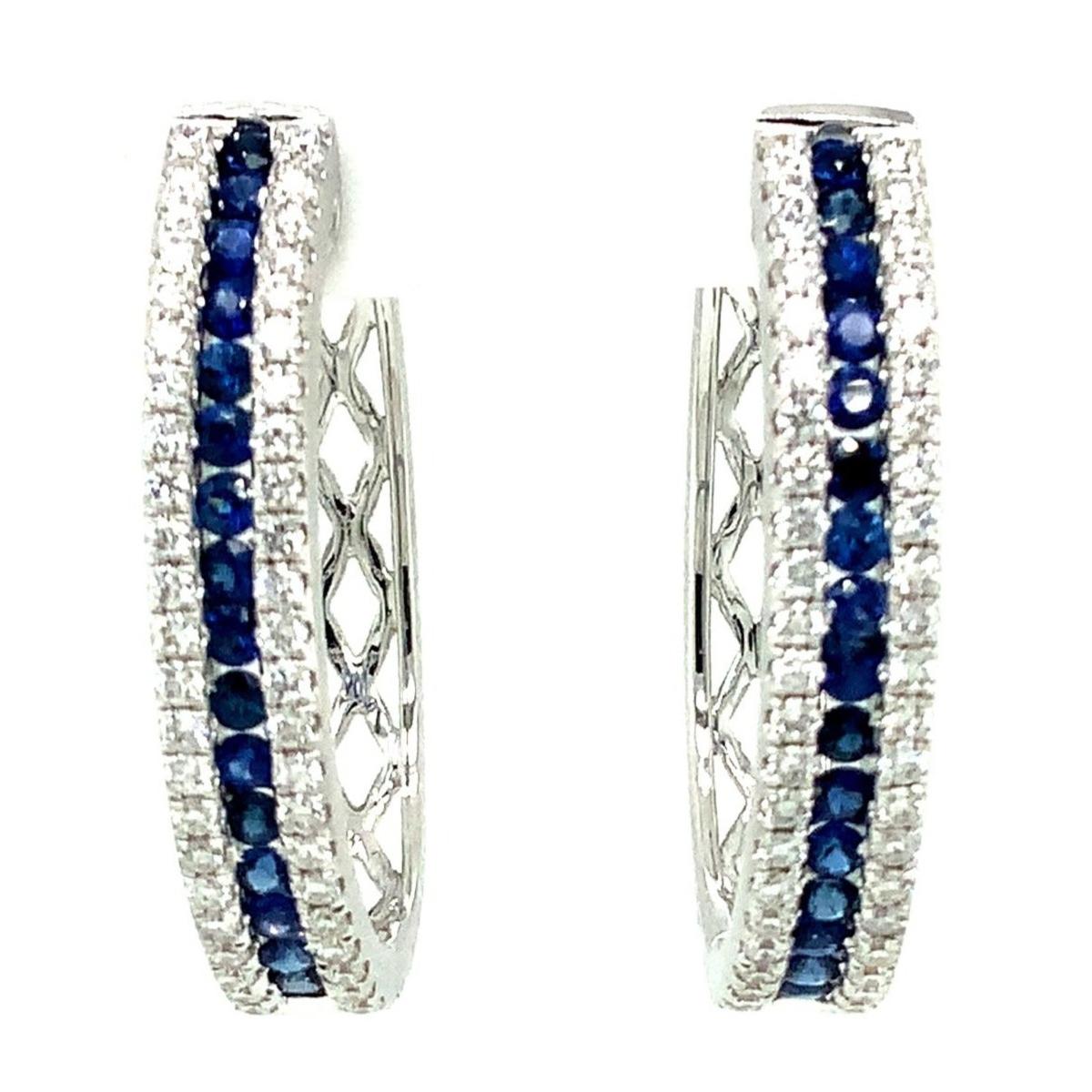 Afarin Collection Blue Sapphire and Diamond Oval Shaped Hoop Earring set in 18K White Gold.  These straight-line designed earrings feature this row of intense Blue Sapphires that are flanked by diamonds.
32 Round Brilliant Cut Natural Blue Sapphire