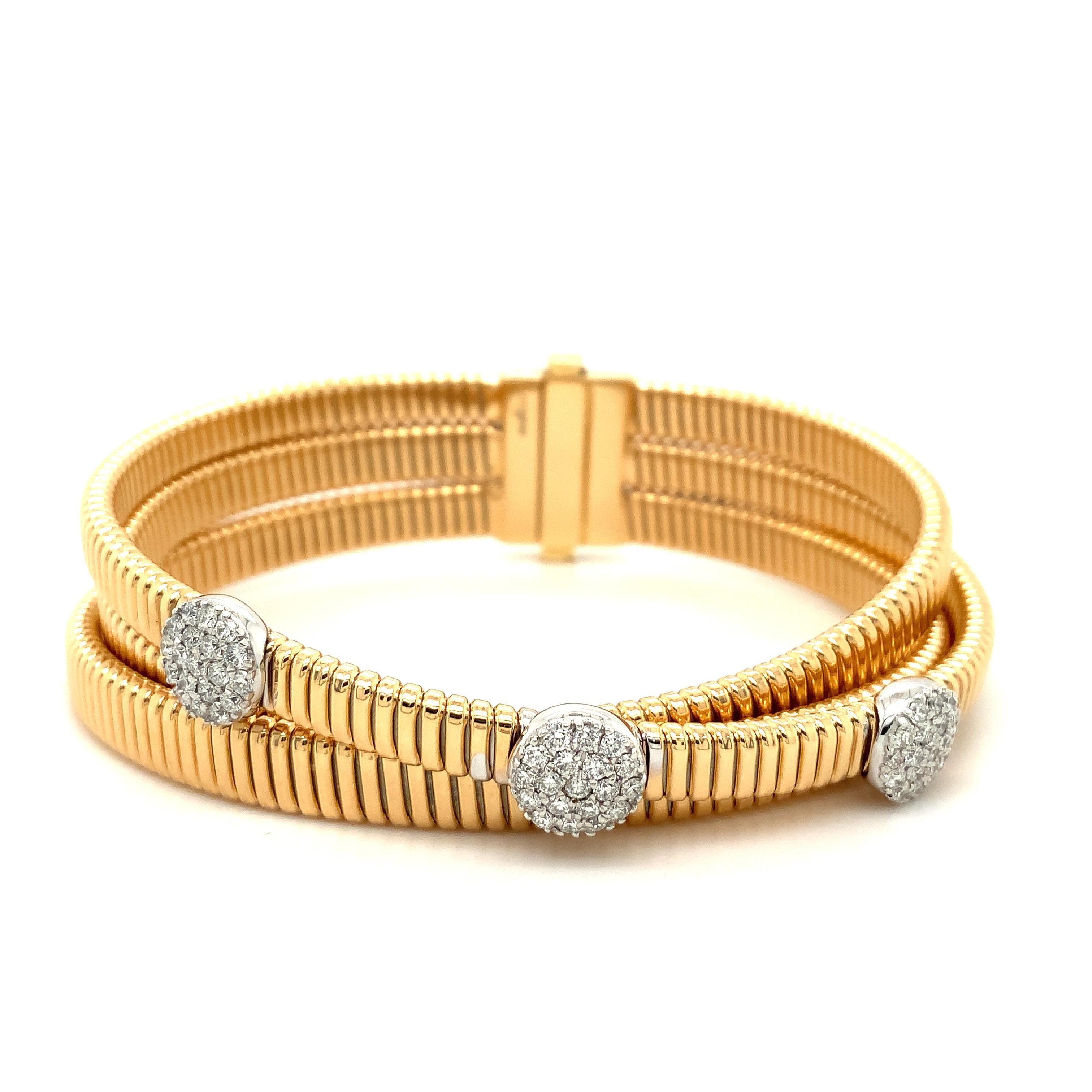 This luxurious, timeless bracelet by Afarin Collection is crafted from 18K yellow and white gold and features an eye-catching triple flexi design with pavé diamonds for a stunning effect. With its delicate and refreshing style, this bracelet is