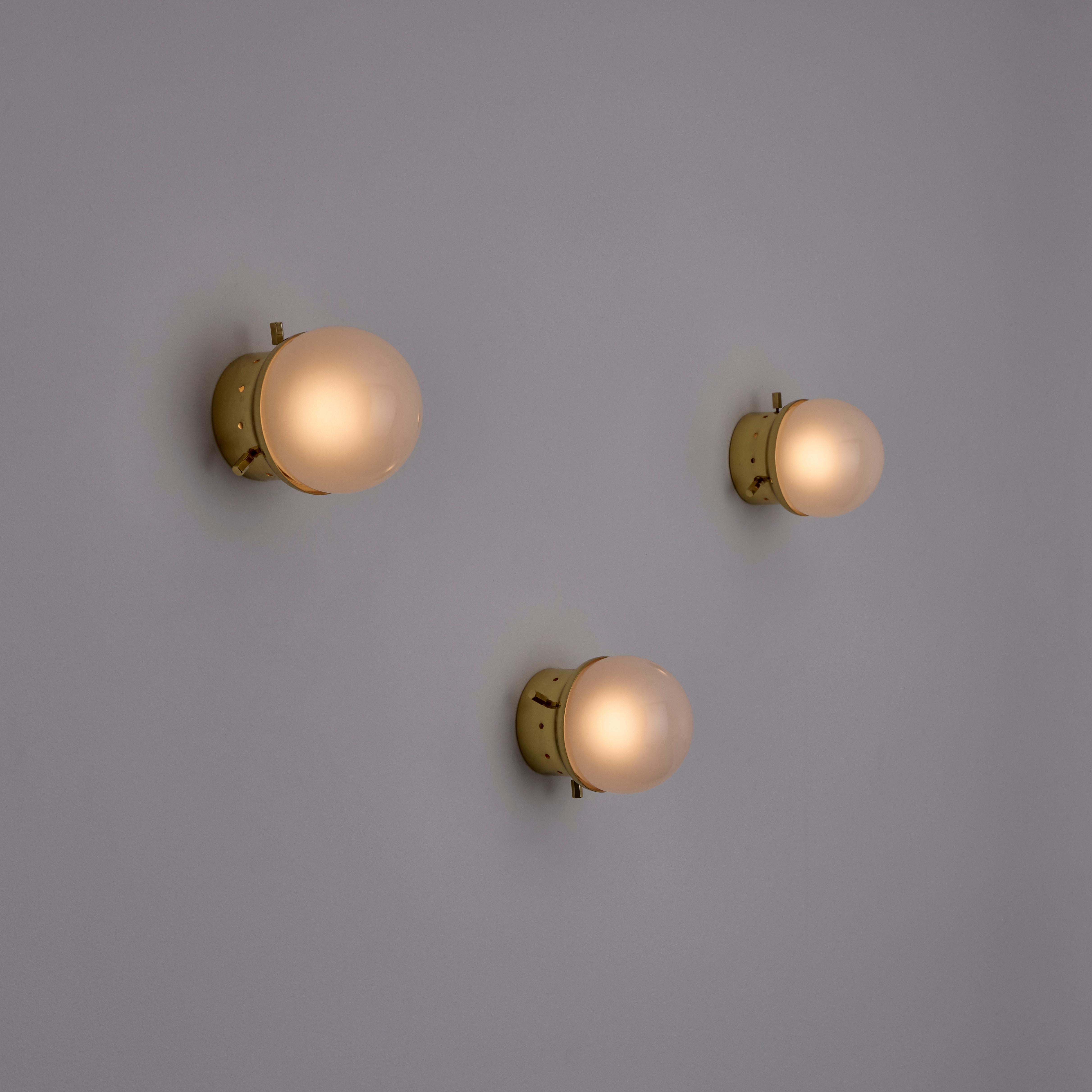 'Affogato' Wall or Ceiling Lights by Azucena (IT, 1990s) 

Sandblasted glass globes paired with polished brass housing. Each sconce holds a single E27 socket-type, adapted for the US, We recommend a single 25-40w max bulb or LED equivalent. Rewired