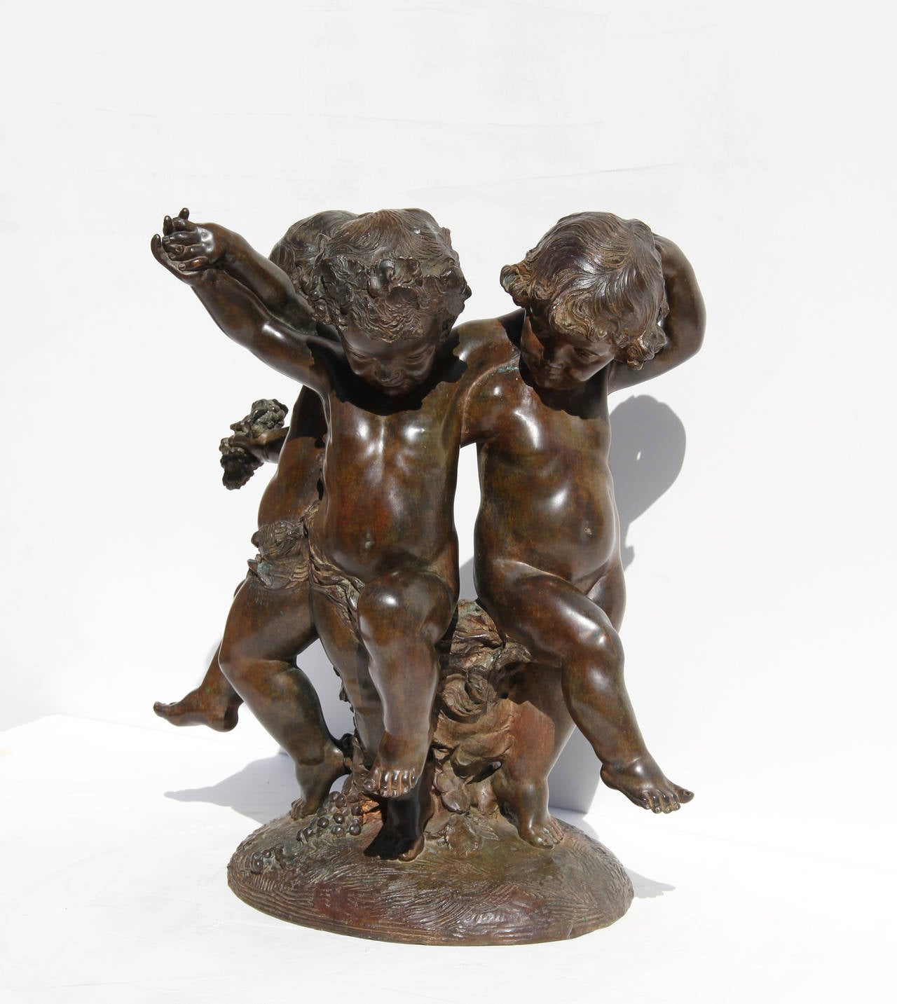 This Bronze sculpture, by the French Art Deco/Art Nouveau artist Affortunato Gory (d. 1925) , is a beautiful moment of three putti joyously dancing together.  Their arms are joined as they dance and hold grapes.  Signature inscribed.