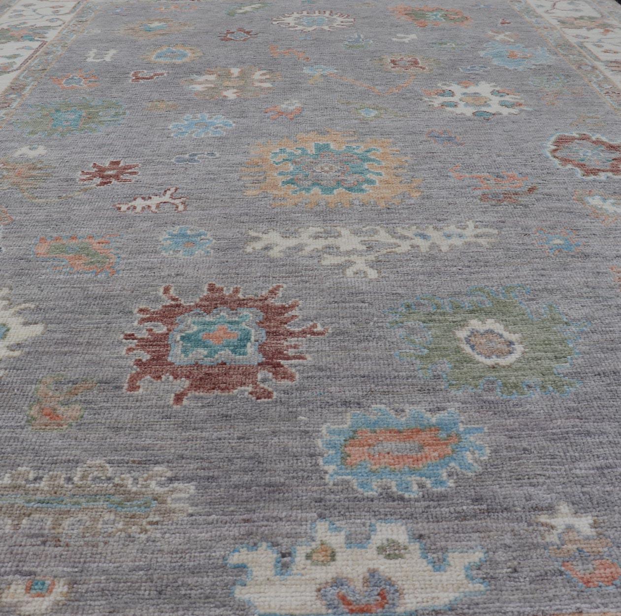 Afghan Hand Knotted Floral Oushak With a Gray Background And Multi-Colors For Sale