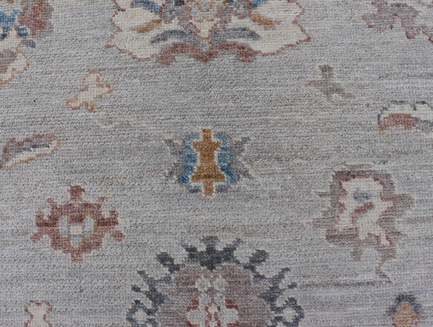 This piece gives a modern vibrancy to the classic floral Oushak design. With a light grey background, the field showcases of cream and taupe in a arabesque design. These same cream and taupe combination can be found in the delicate border.
Measures;