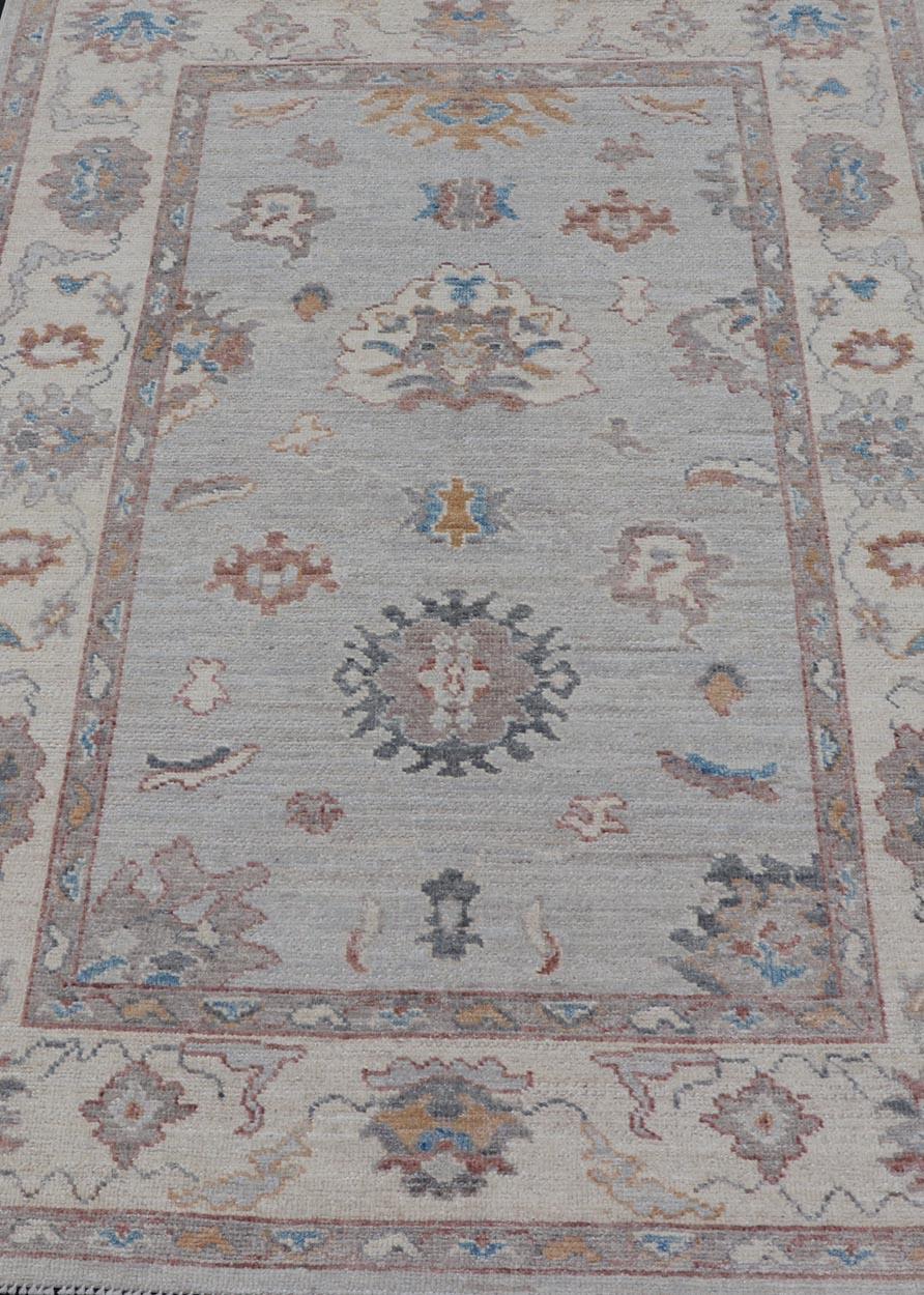 Afghan Floral Oushak with Muted Gray Background and Cream Border For Sale