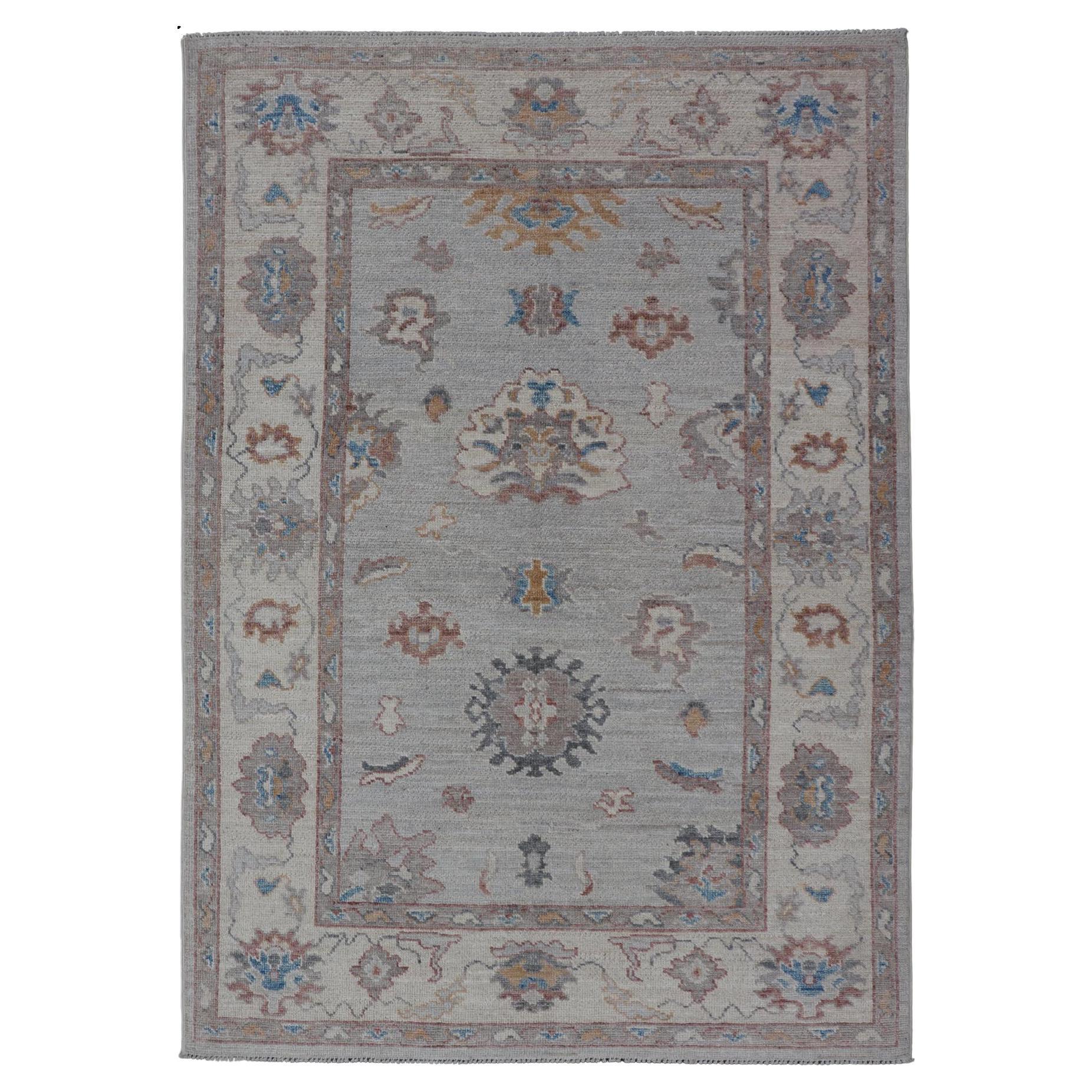 Floral Oushak with Muted Gray Background and Cream Border For Sale