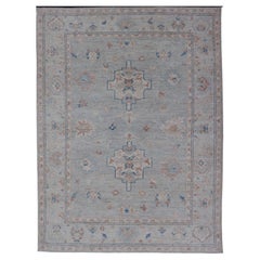 Hand-Knotted Oushak with A Light Blue Background and Tribal Motifs