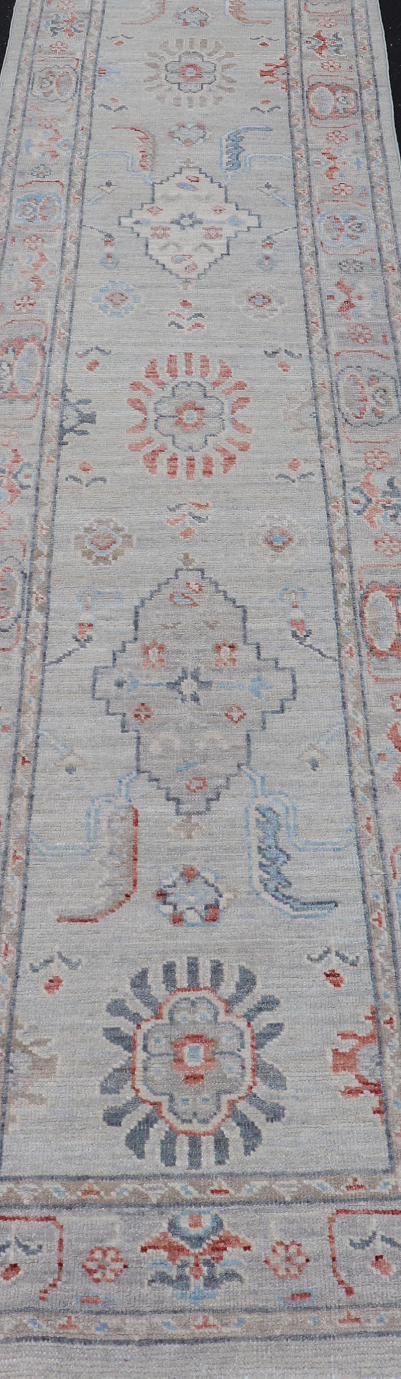 Hand-Knotted Afghan Hand Knotted Oushak with Coral and Blue Motifs on Light Gray Background For Sale